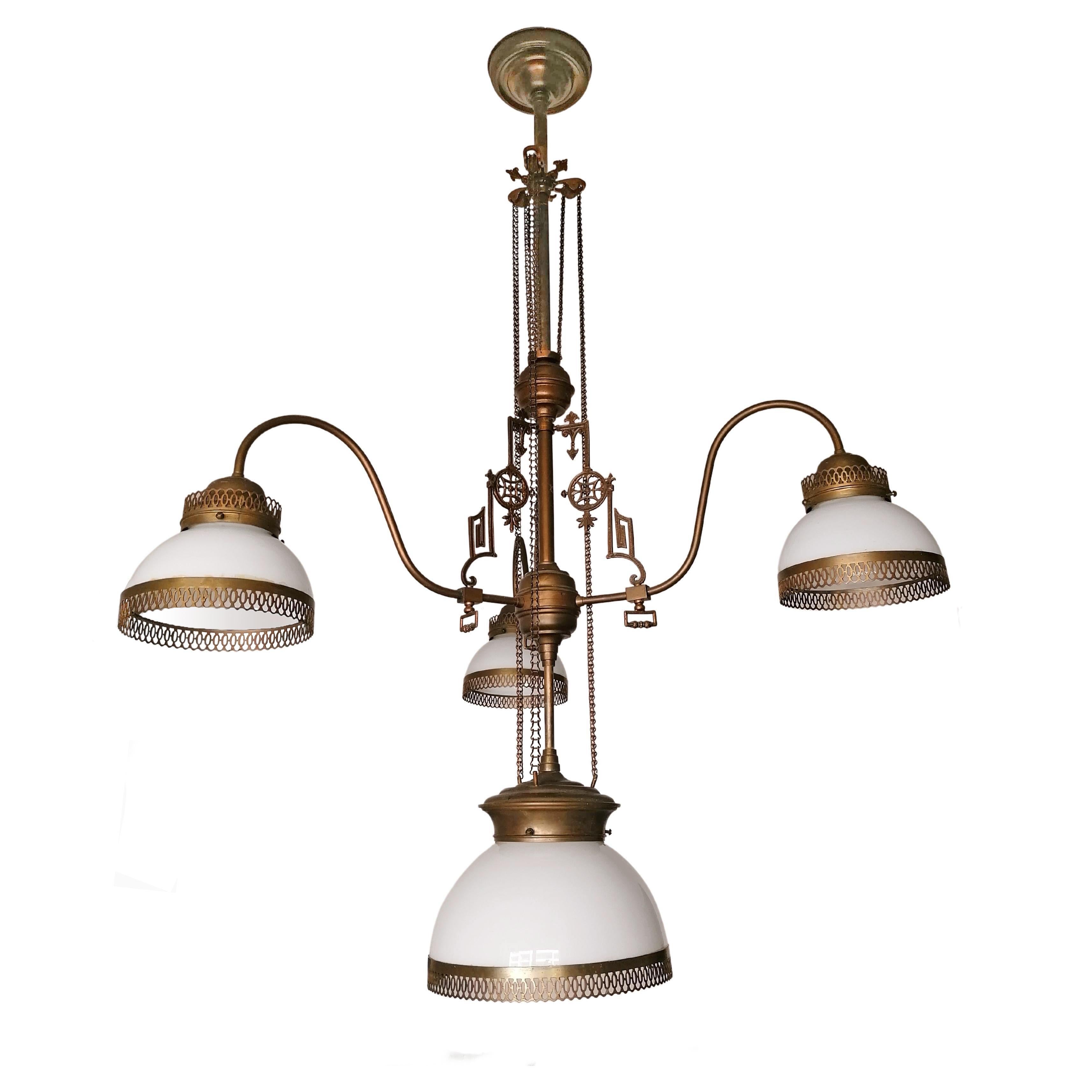 Stunning French Art Deco chandelier in Opaline glass and burnished brass with brass Trimmig and Chains, circa 1920. In mint condition. The height of the chandelier is regulated by the traction chains extending or shortening the rod which holds the