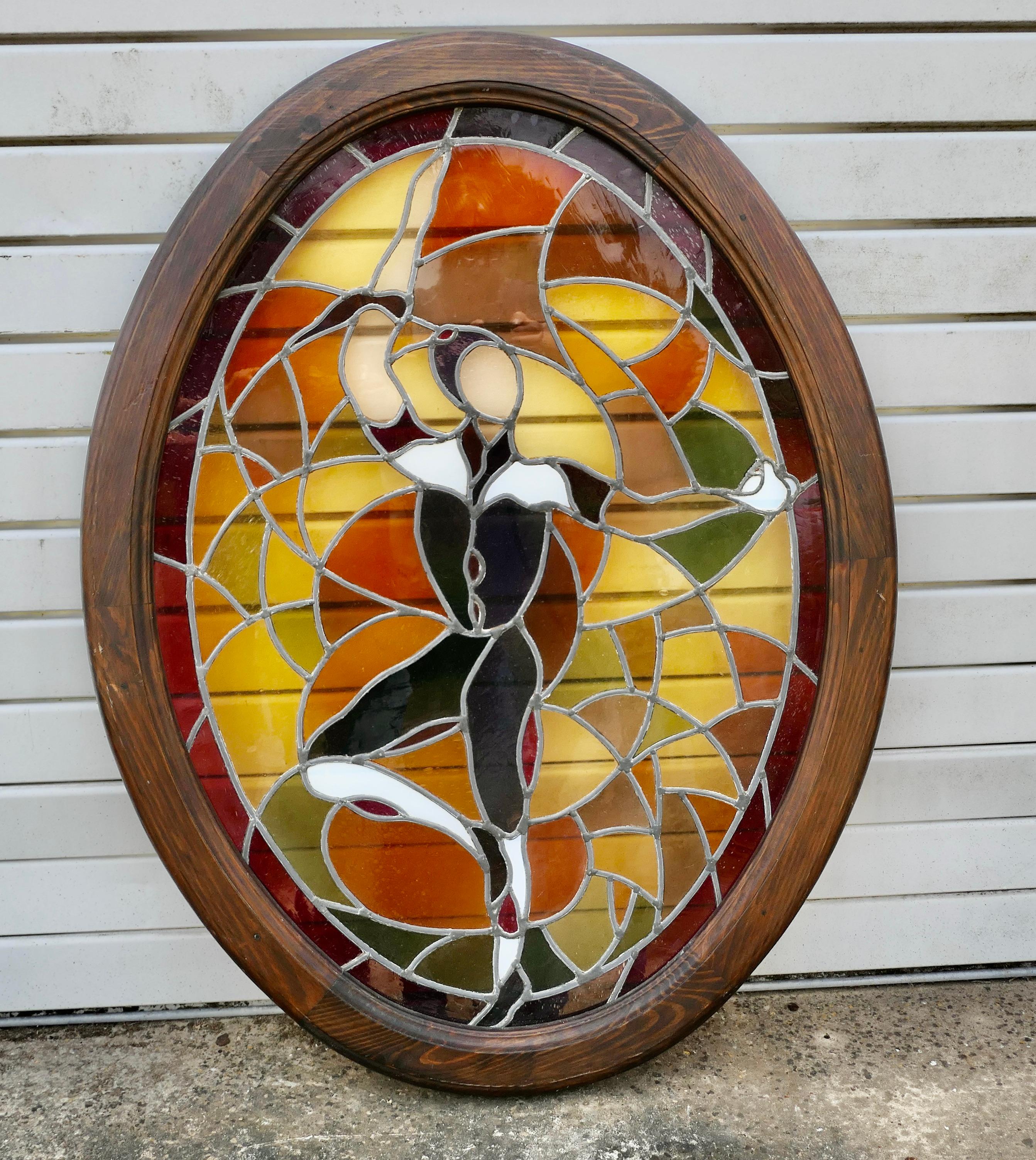 Large French Art Deco Stained Glass Panel for a Window or Door

This is a lovely piece, it has very attractive leaded glass in beautiful autumn colours with a handsome dancer set in the centre
The glass has been built into an Oval solid wooden 3”