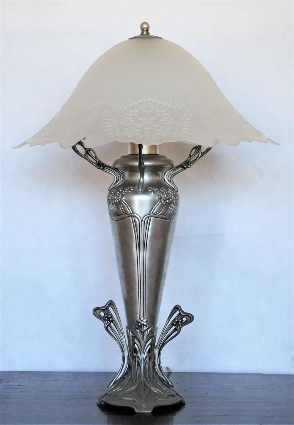 A large Art Deco handcrafted pewter vase shape table lamp with beautiful high relief glass shade, France 1930s.
One E27 light bulb socket.
Measures:
Height 25 in (63.5 cm)
Diameter 16 (40.5 cm).