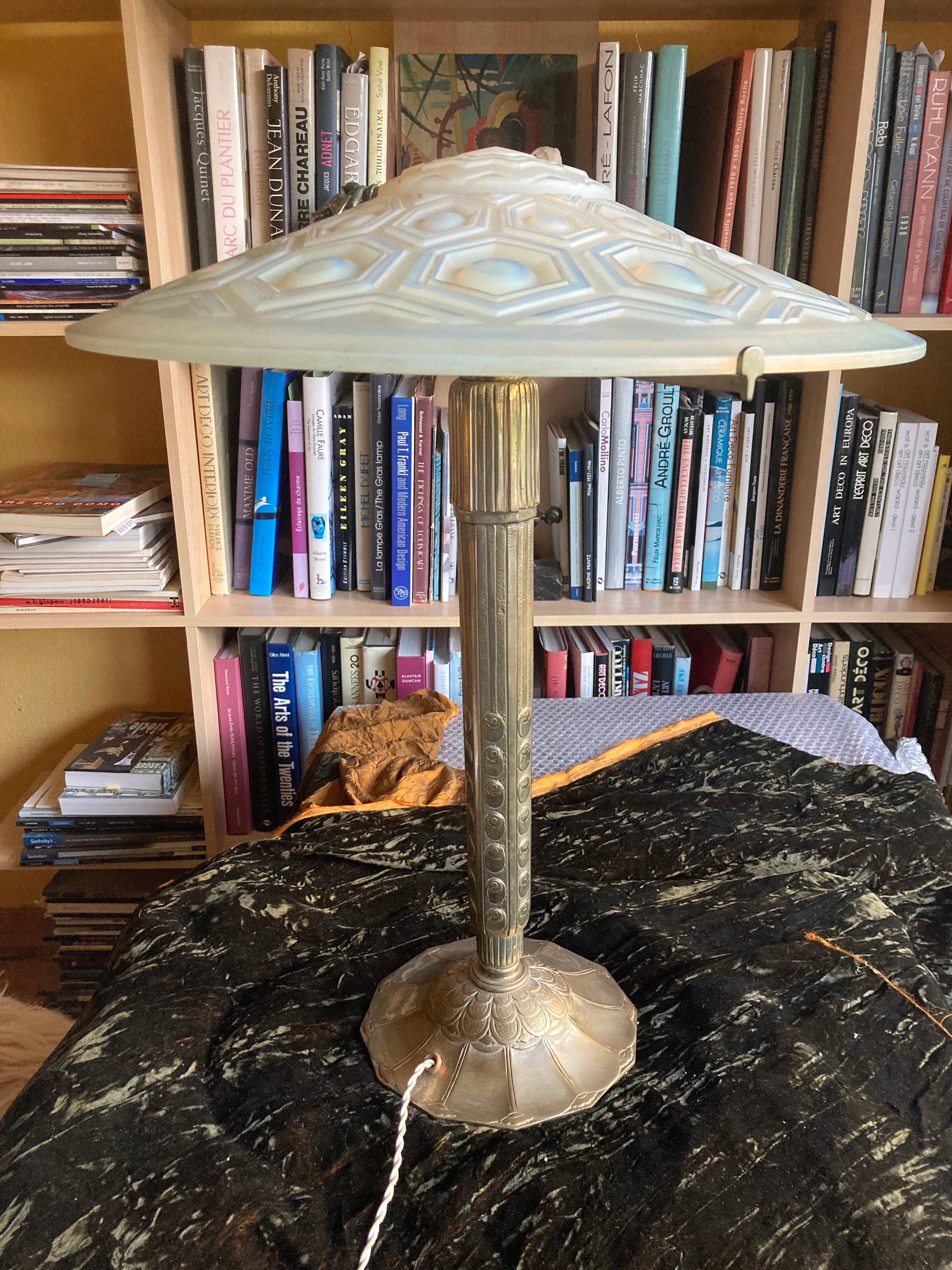 Large french Art Deco table lamp. Signed in the shade A.Kovazs France.
Modelled Opaline glass. Silver plated bronze lamp base by Yves Granger. Documented.
The lamp has been re-electrified by a professional.
The elaborate base has a diameter of 22