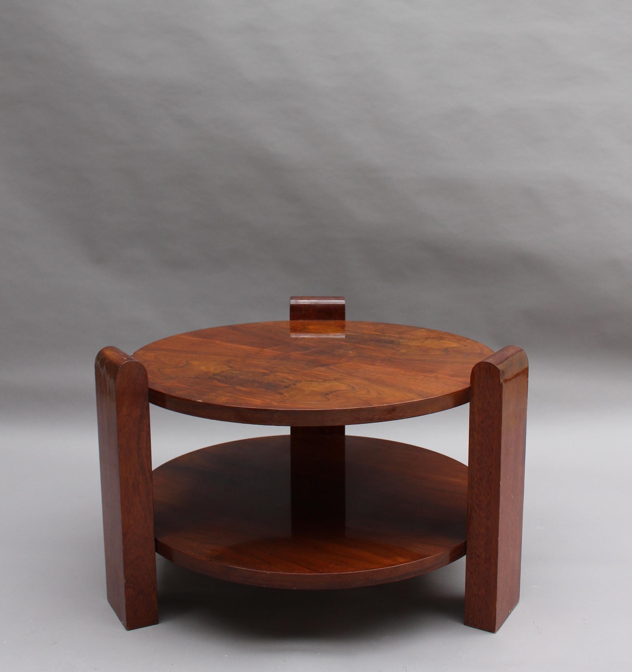 A large French Art Deco two-tier walnut gueridon.
Overall dimensions are W 34 in. H 21.5 in.