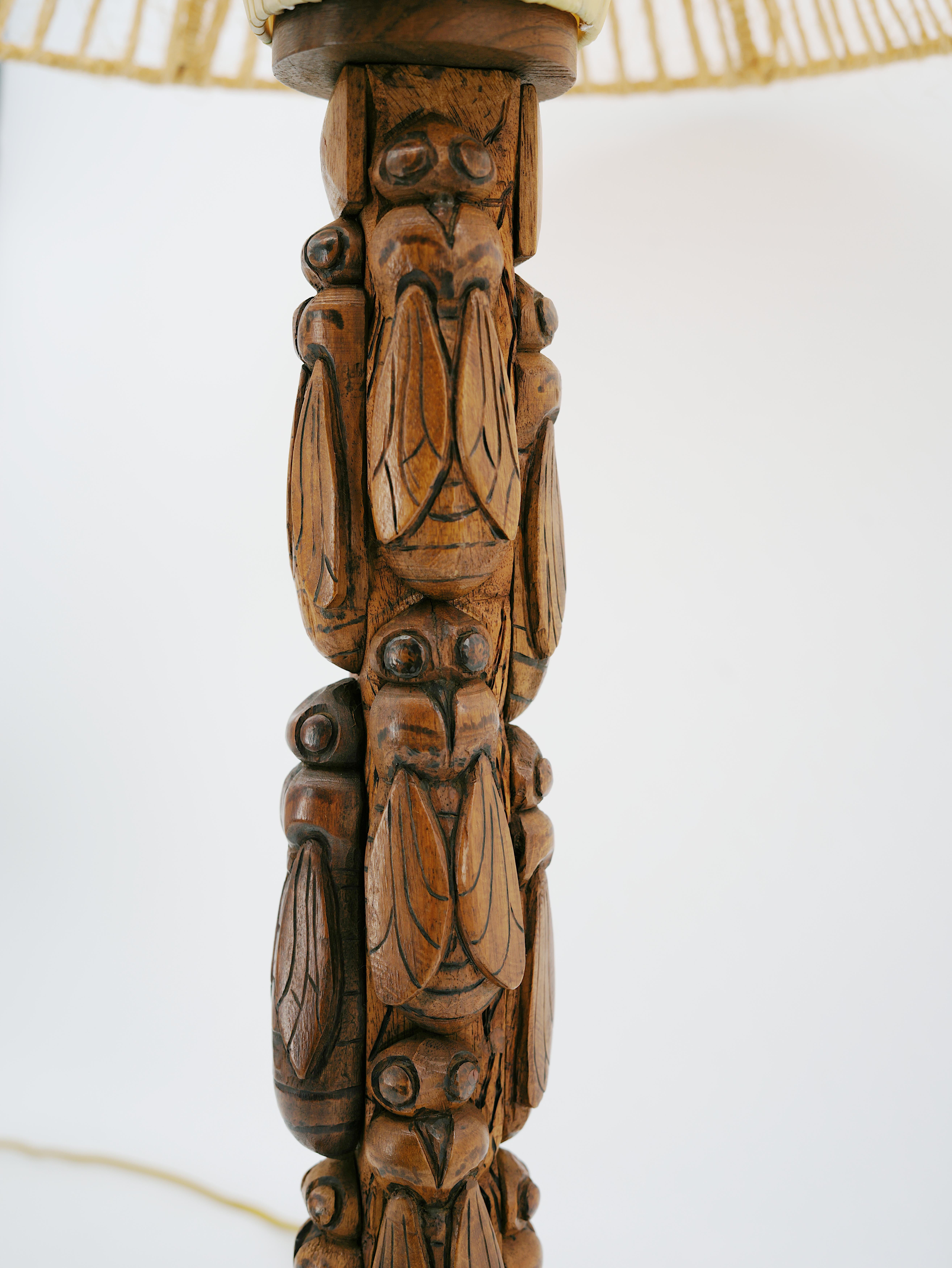 Gran lámpara de mesa francesa Art Dec�ó, Francia, años 30 - Madera tallada con motivo de cigarra, al estilo de Charles Dudouyt

Esta impresionante lámpara de mesa francesa Art Déco de los años 30 presenta una escultural base de madera tallada