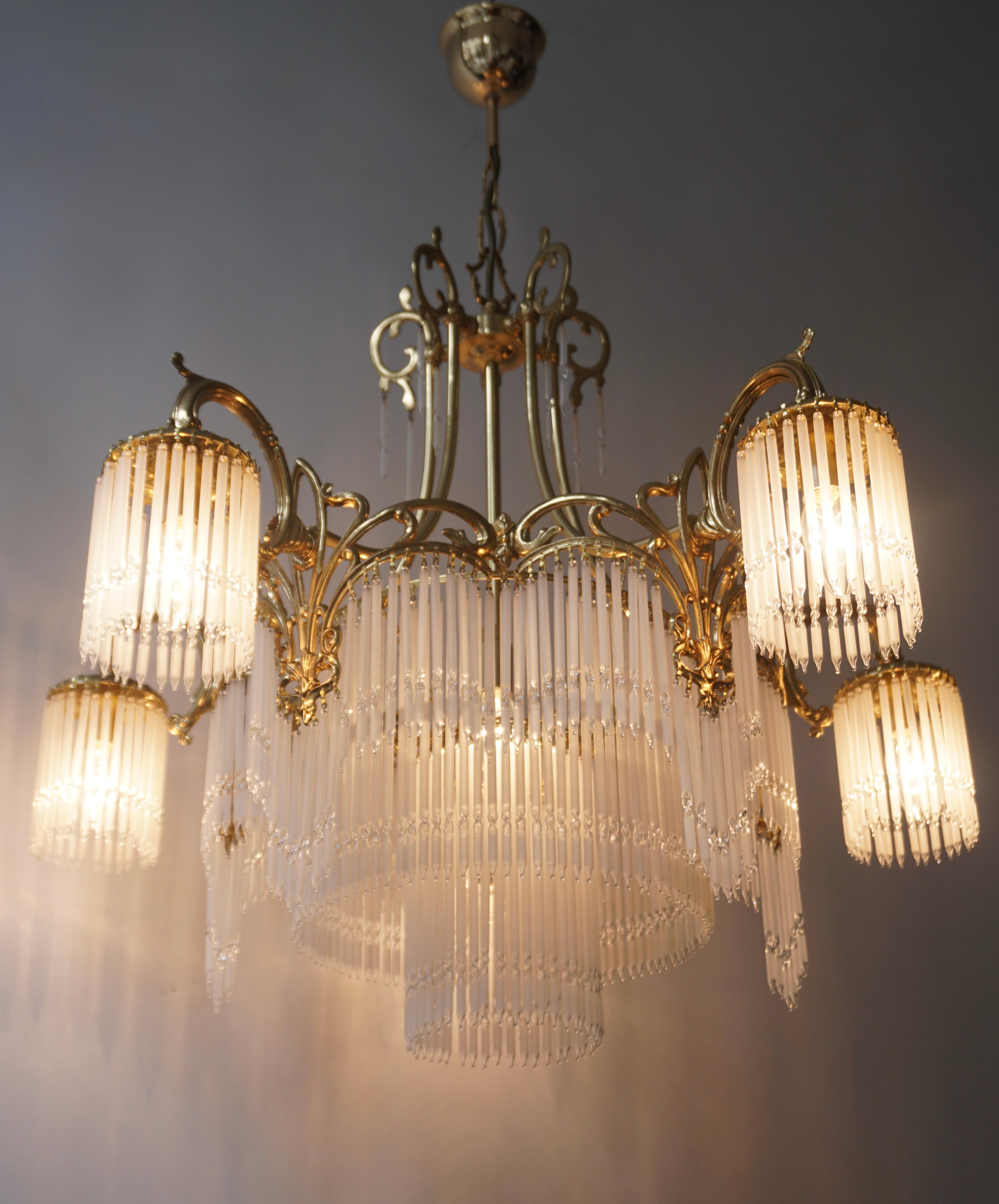 Gorgeous and very rare chandelier in brass and glass rods France. 
The chandelier is simply a jewel !

The light requires six single E14 screw fit lightbulbs (60Watt max.) LED compatible.

Diameter 74 cm.
Height fixture 67 cm.
Total height 90
