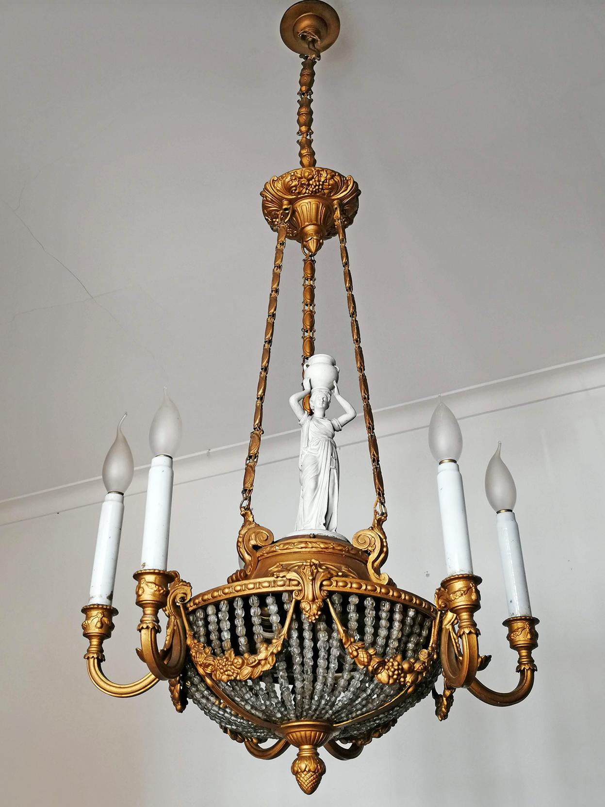 A wonderful gilt bronze and beaded-glass 8-light ceiling fixture decorated with fine ornaments and garlands, France, late 19th century. Porcelain caryatid and white glass candles.
Measures:
Diameter 21.7 in/ 55 cm
Height 53.2 in (chain 15.8 in)/