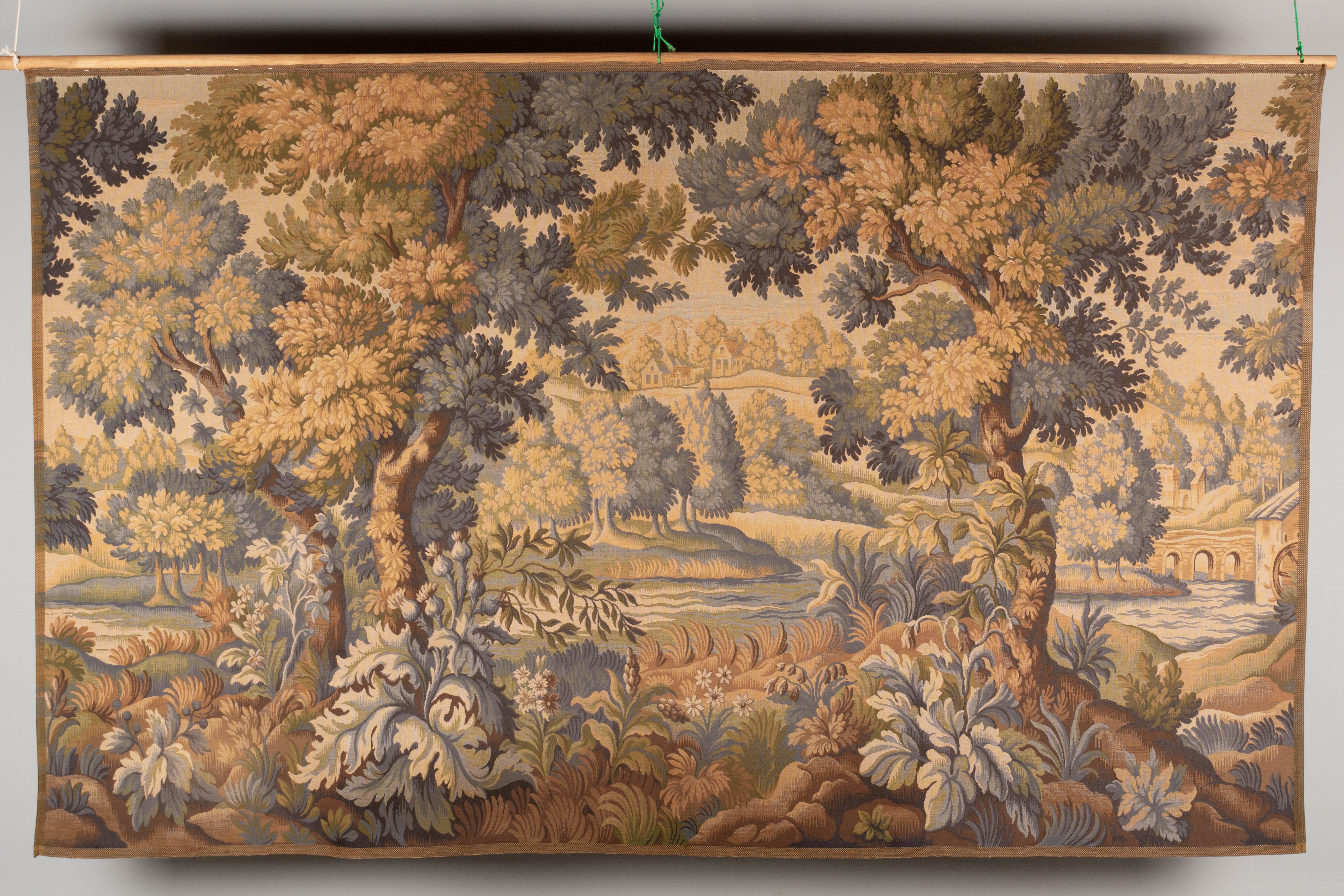 A large French Aubusson verdure wool tapestry, or wall hanging. Mechanical woven wool with the look of petit point in beautiful subtle muted blue, green and gold coloring. Very good condition. Label on back. Does not include hanging rod, will ship