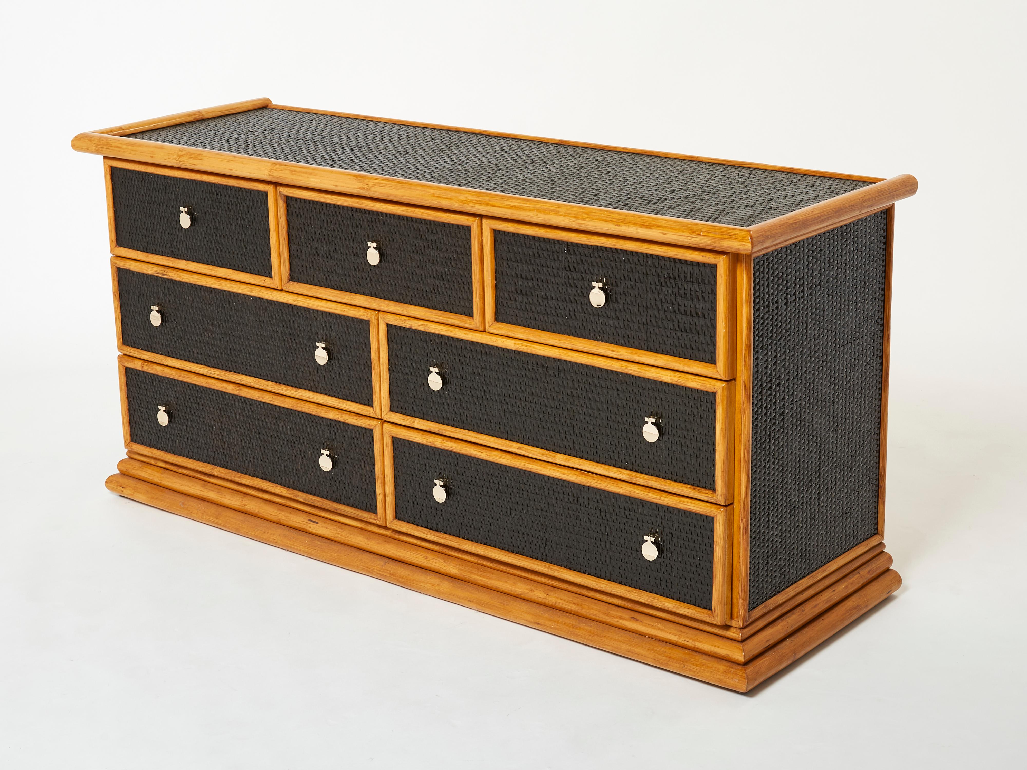 Natural bamboo and rattan are the chief materials creating a summery, organic aesthetic in this 1960s French commode chest of drawers, while bright brass handles add the chic, eye-catching touches. The brass handles on the drawers are lovely