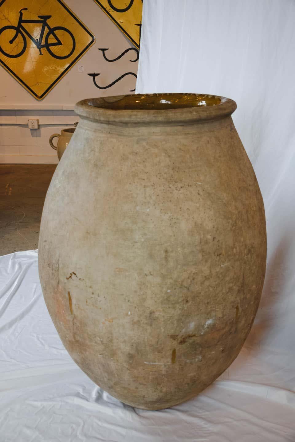A beautiful French olive jar from the Biot region of France. The Alpes-Maritimes region has been known as a pottery center of France from the 18th century to the present. These pots are beautiful standing alone or planted with greenery.

H 42 in.