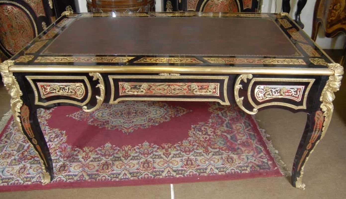 You are viewing a wonderful, sumptuos Boulle style partners desk. The piece is very distinctive and the amount of craftmanship that has gone into making this piece is astounding. The main wood to the piece is black over which there is some very