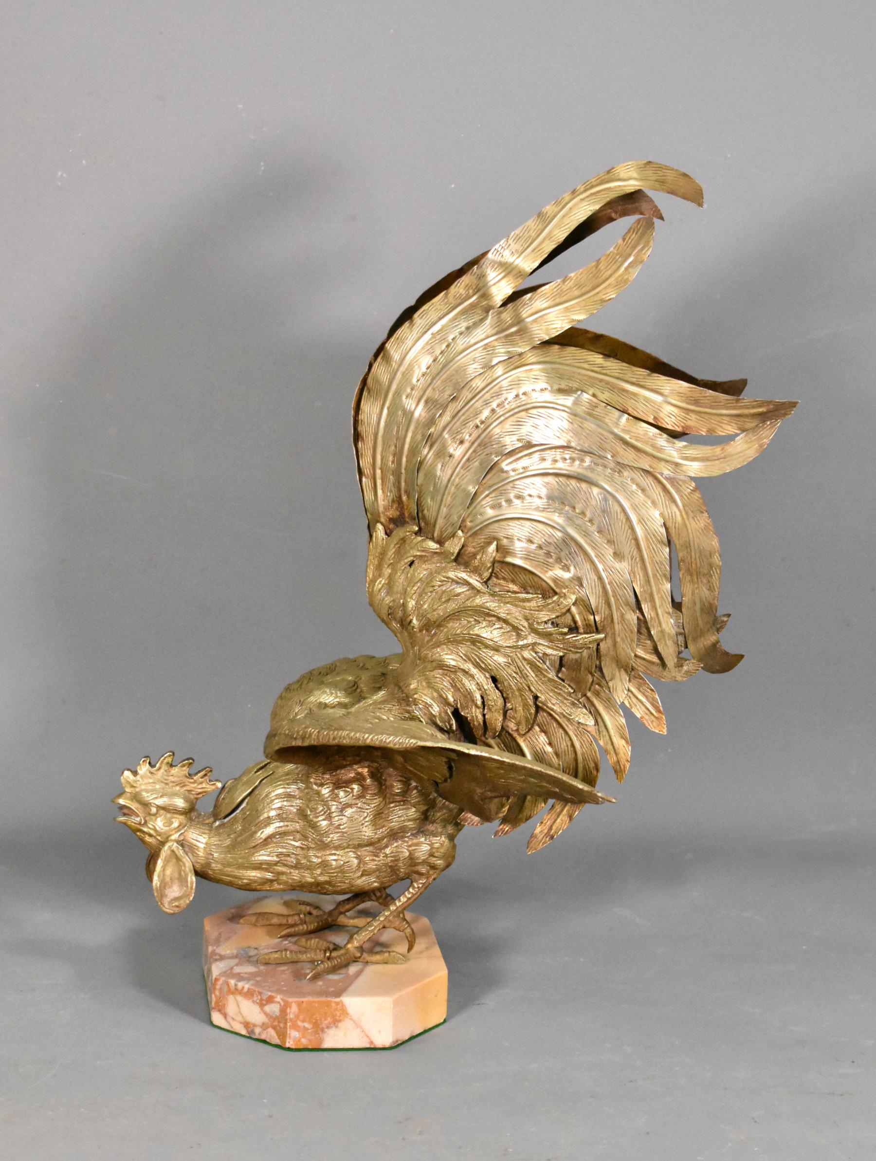 Large French brass cockerel rooster 

An impressive large French brass cockerel stands in a fighting pose with its wings out-stretched and tail held high. 

The piece shows great attention to detail throughout and retains its original patina.