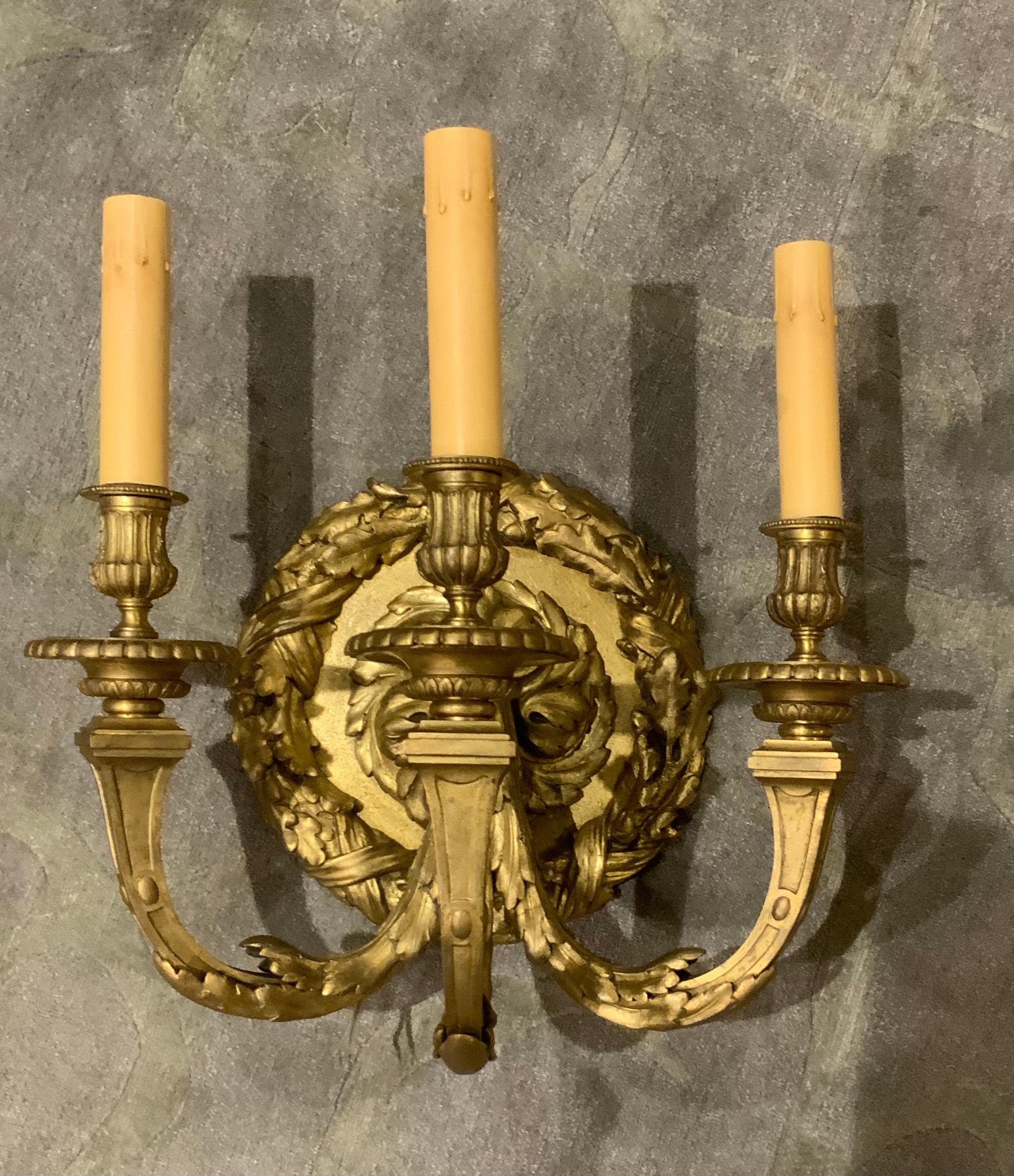 Large and distinguished bronze dore sconce with a central
Decorative swirling feature which the three large arms
Eminate. The arms curve upward to hold three lights.
The sconce is wired and ready for installation. The central 
Design is