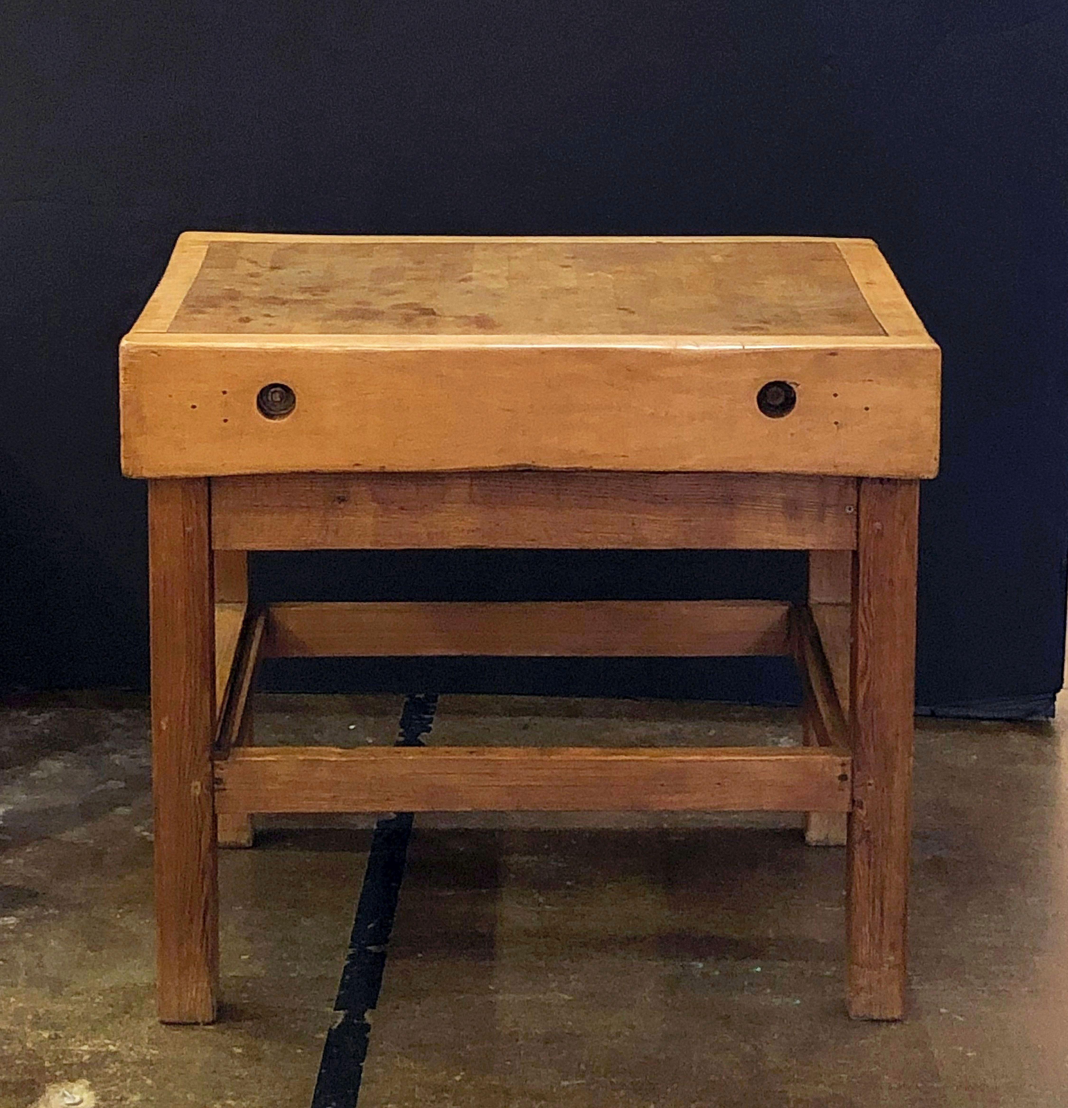 A handsome large French butcher's chopping block table, featuring a large, rectangular block or slab of wood set upon a bottom tier four-legged support stand. Ships in two pieces.

Makes a great kitchen island or serving console.