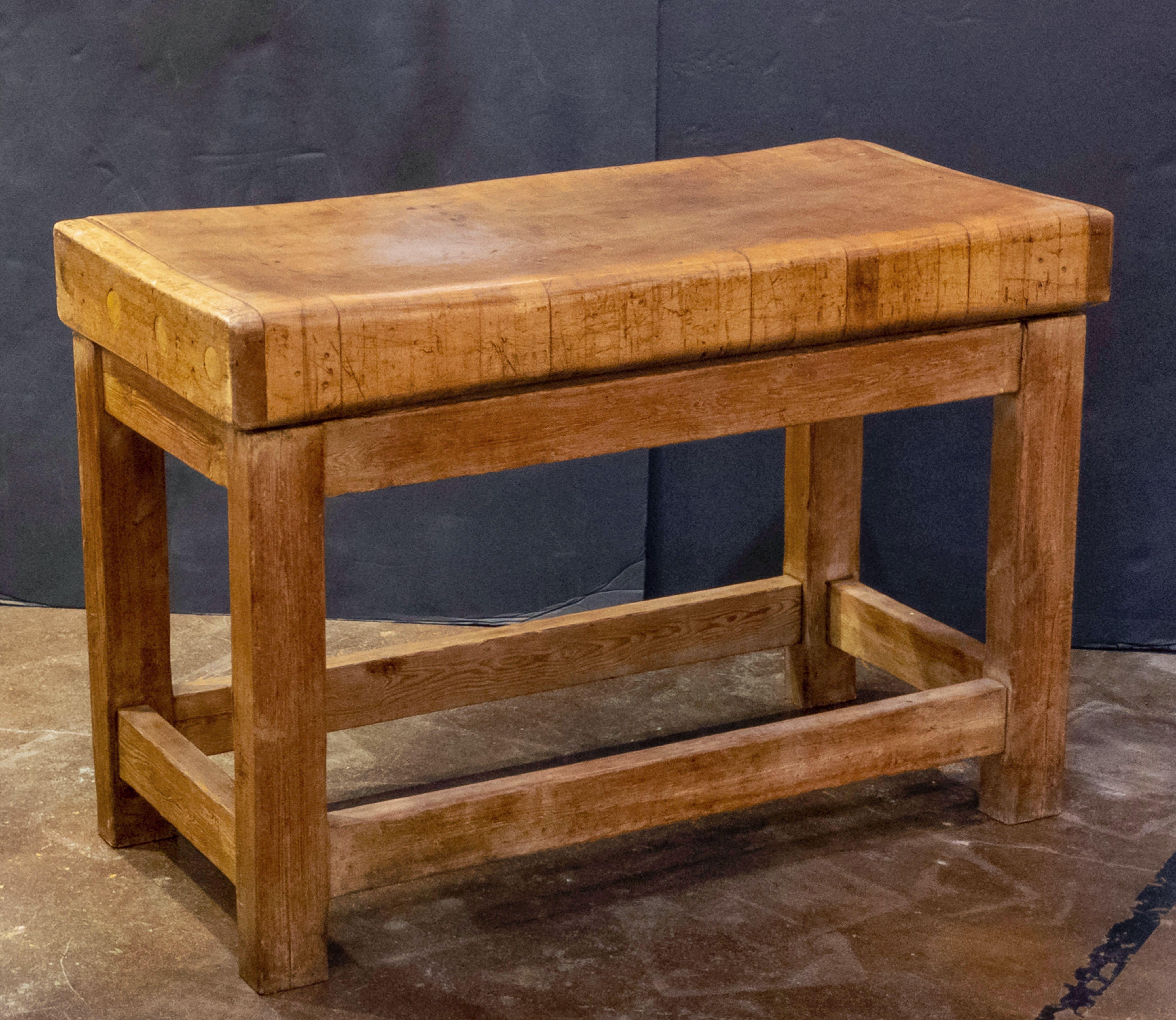 A handsome large French butcher's chopping block table, featuring a large, rectangular block or slab of wood set upon a bottom tier four-legged support stand. Ships in two pieces.

Makes a great kitchen island or serving console.