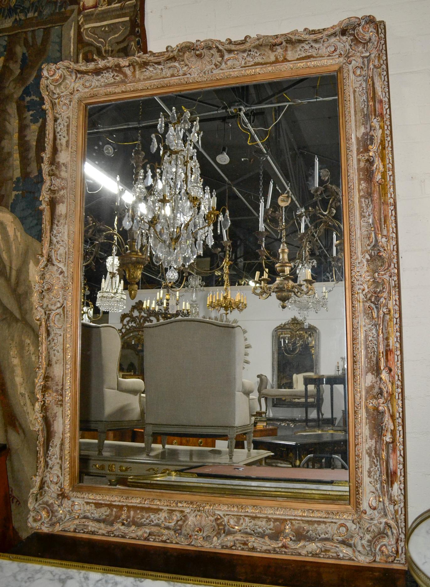 Impressive large scale French carved giltwood mirror.