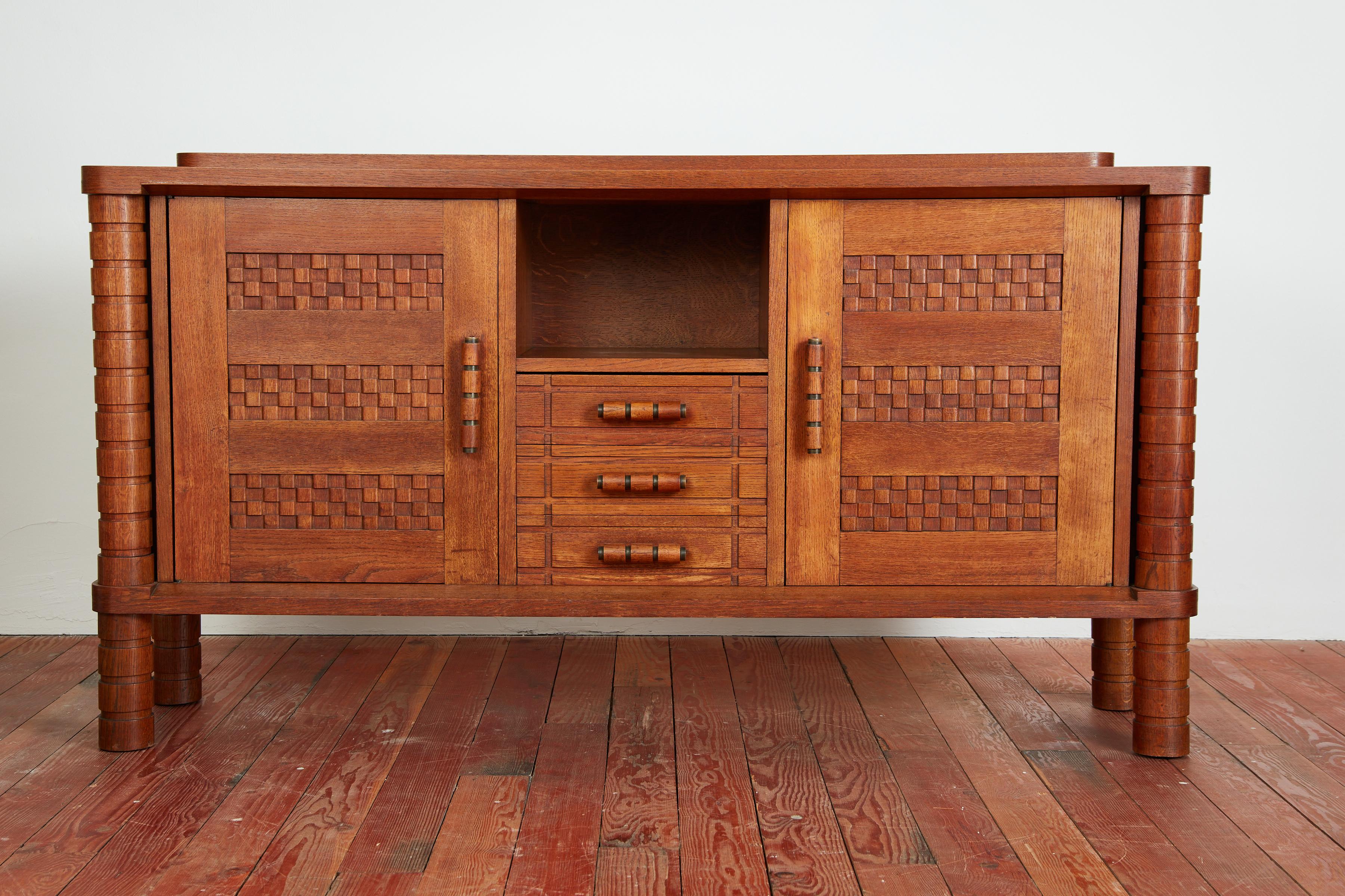 Absolutely gorgeous French Oak Sideboard with carved legs, door fronts and handles.  Impressive in size and wonderful original patina. 
Extremely well made and heavy. 
France, circa 1940's 
In the style of Charles Dudouyt - this one is a stunner! 