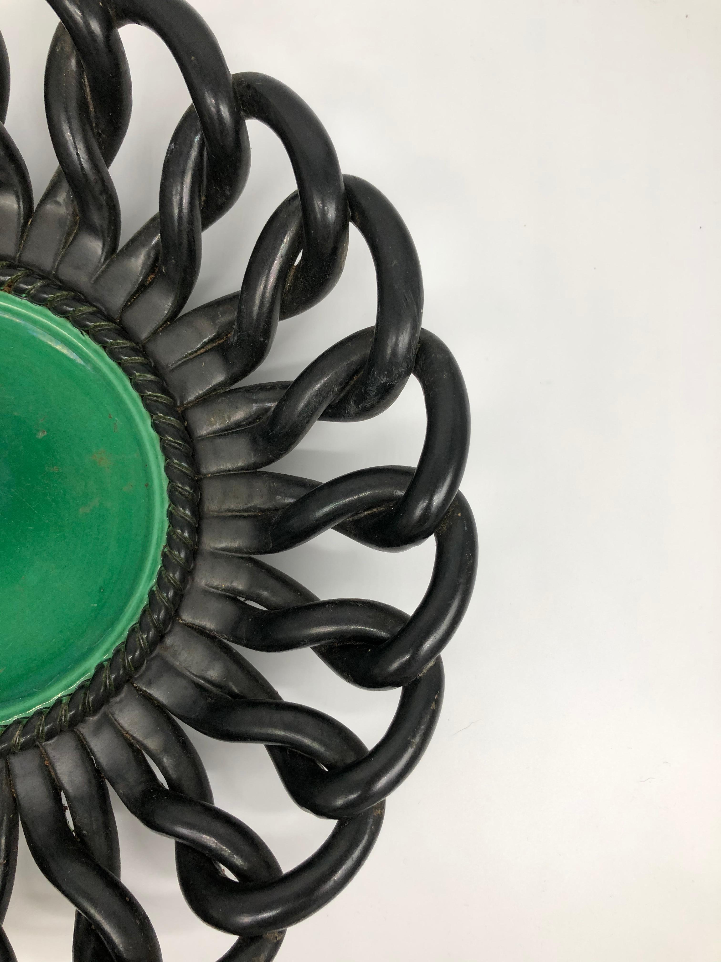 Large dish, green and black enameled ceramic, decorated with interlaced rim, French, 1950s.