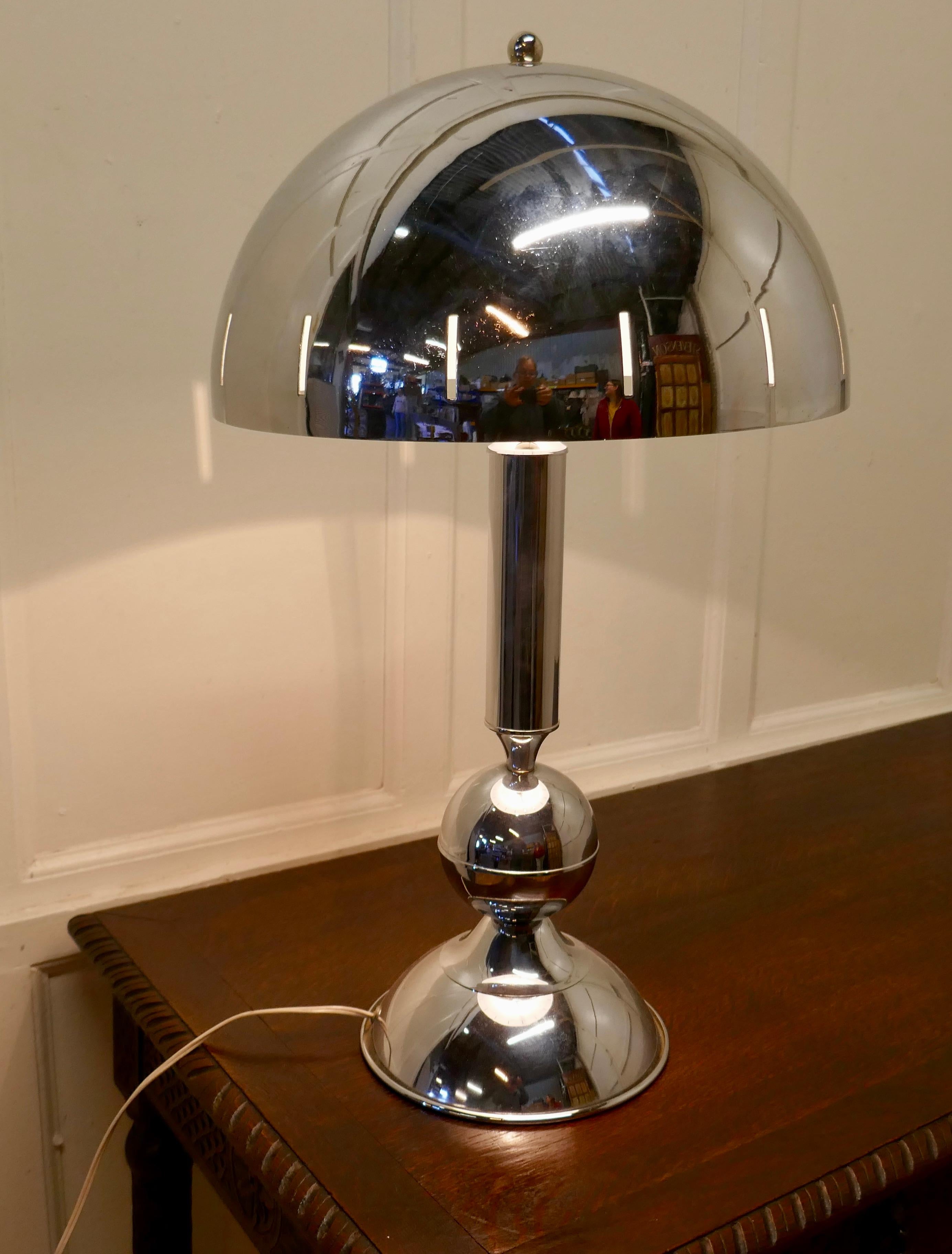 Large French chrome retro style table lamp

Very stylish statement piece in dynamic chrome, with a large mushroom shaped shade and a tall central column
The lamp is 27” tall, and 16” in diameter
WD67.
