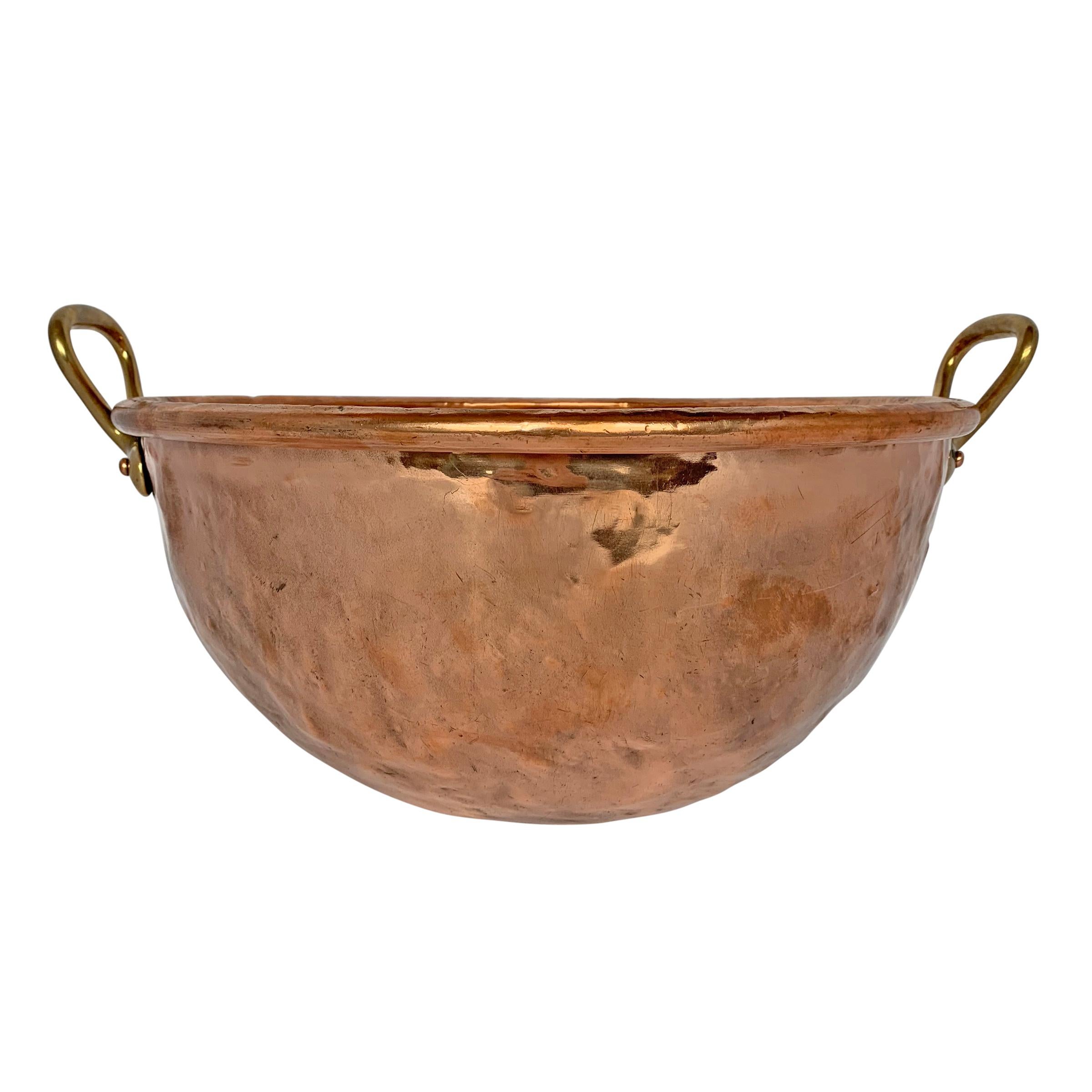 A fabulous and large early 20th century French copper confectioner's pot with large bronze handles and a wonderful patina. We think this would make a fantastic vessel sink in a kitchen and/or powder room.