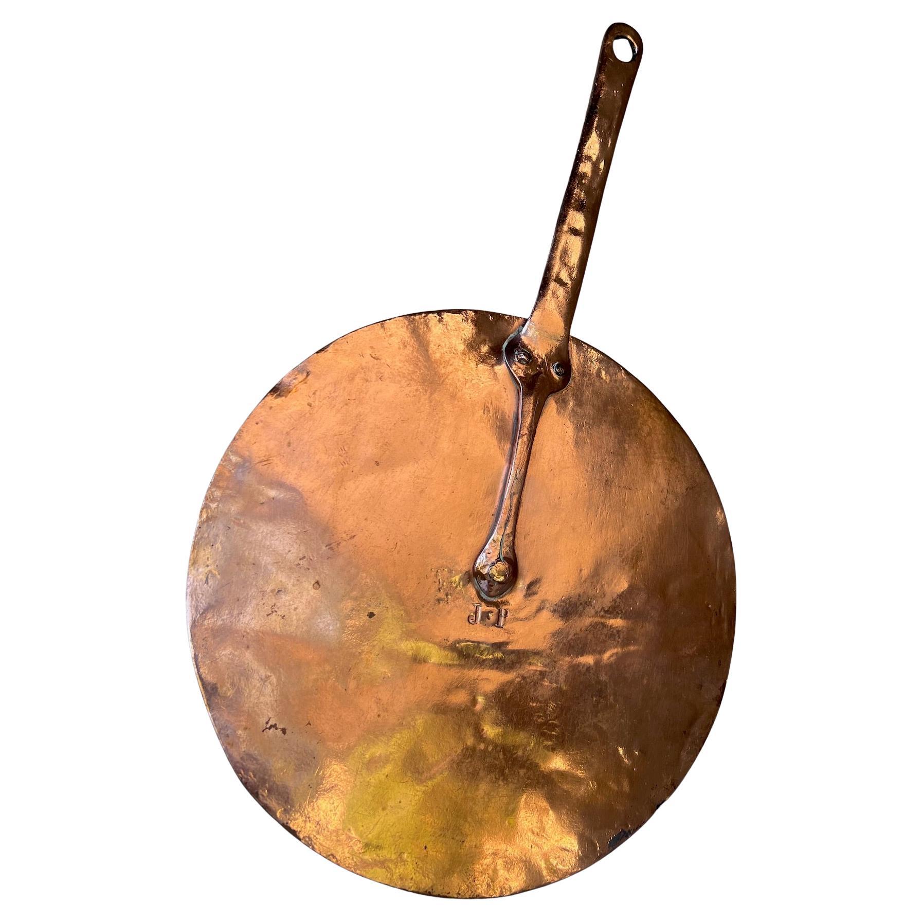 Large hand crafted copper lid with hand forged handle. The top is stamped with the initials J.P.

Flat to cover most pans,  the lid itself is 11.38 wide