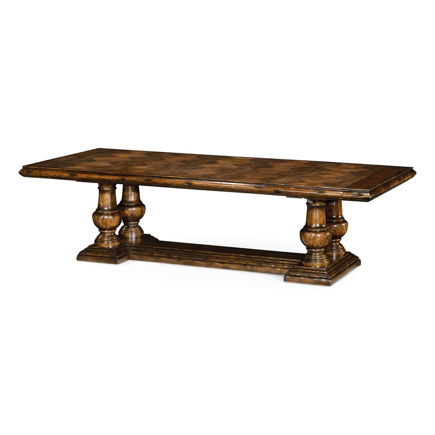 A large French country walnut extending dining table with heavily distressed driftwood. The top with an unusual parquetry design with a deep molded edge on four bold turned baluster columns and a thick H for stretcher base.

Open dimensions: 146