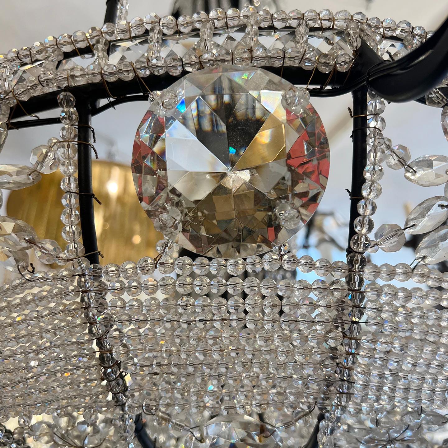 A circa 1950s French crystals chandelier with 10 lights.

Measurements:
Height: 49