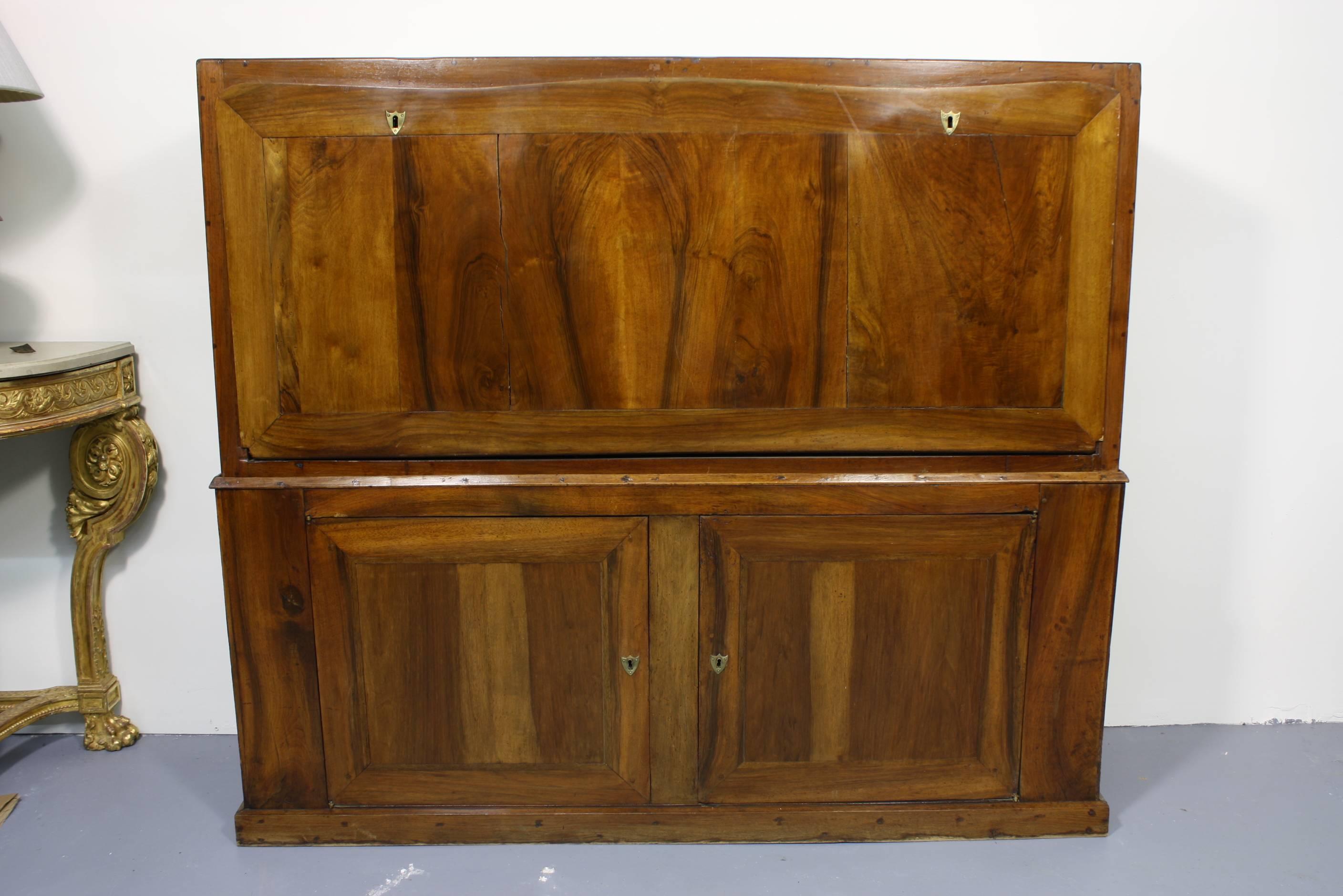 This French Directoire traveling secretary is made of walnut. Its large size is unusual and would make an impressive statement in a study. The top section of the secretary is period, dating from the end of the 18th century, while the base was