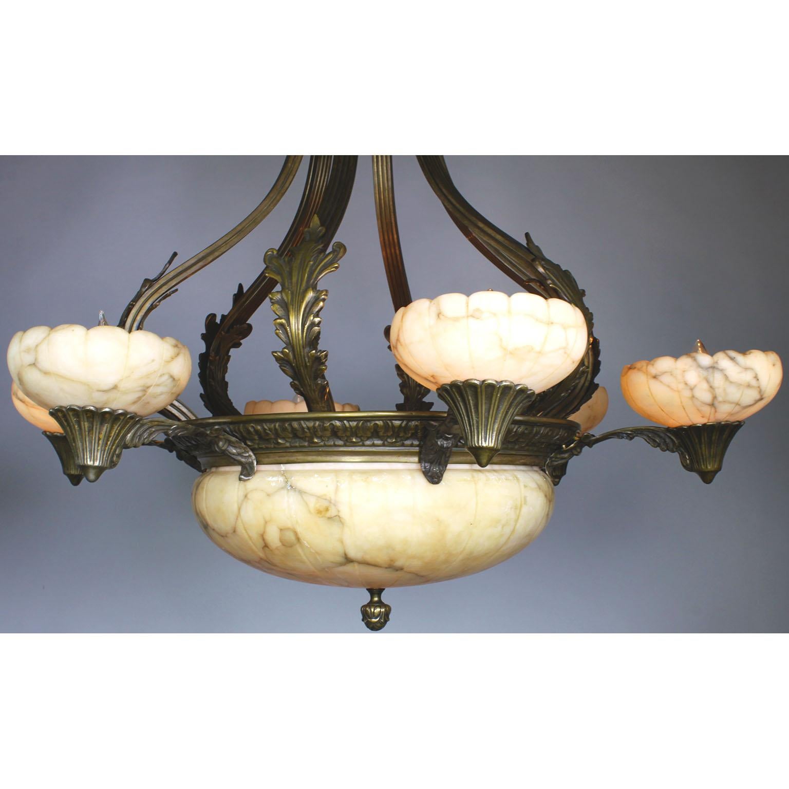 A large French early 20th century Art-Deco bronze and carved veined ivory-colored alabaster six-light chandelier. The carved circular alabaster plafonnier with a floral bronze apron and four interior lights, surmounted with six alabaster cone-shaped