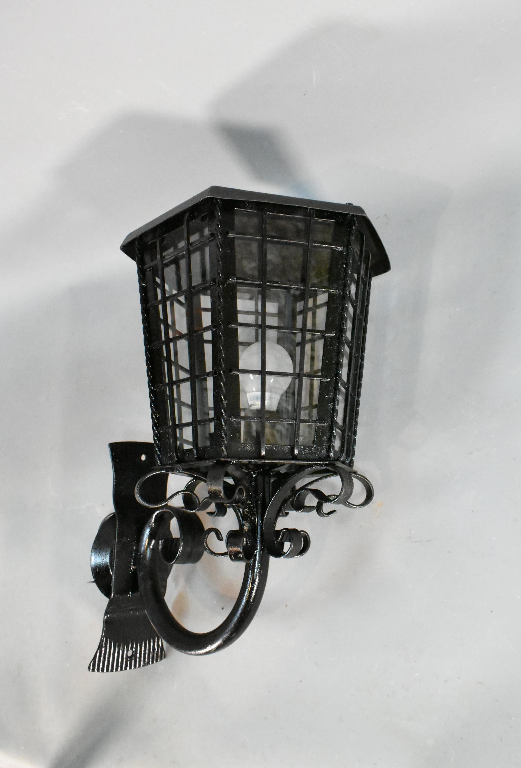 Large French Exterior glazed cast iron Lantern 

An impressive wall-mounted exterior cast iron lantern that has been refurbished, rewired and repainted. 

This hexagonal lantern sits on a swirling tubular arm with decorative swirls adorning the