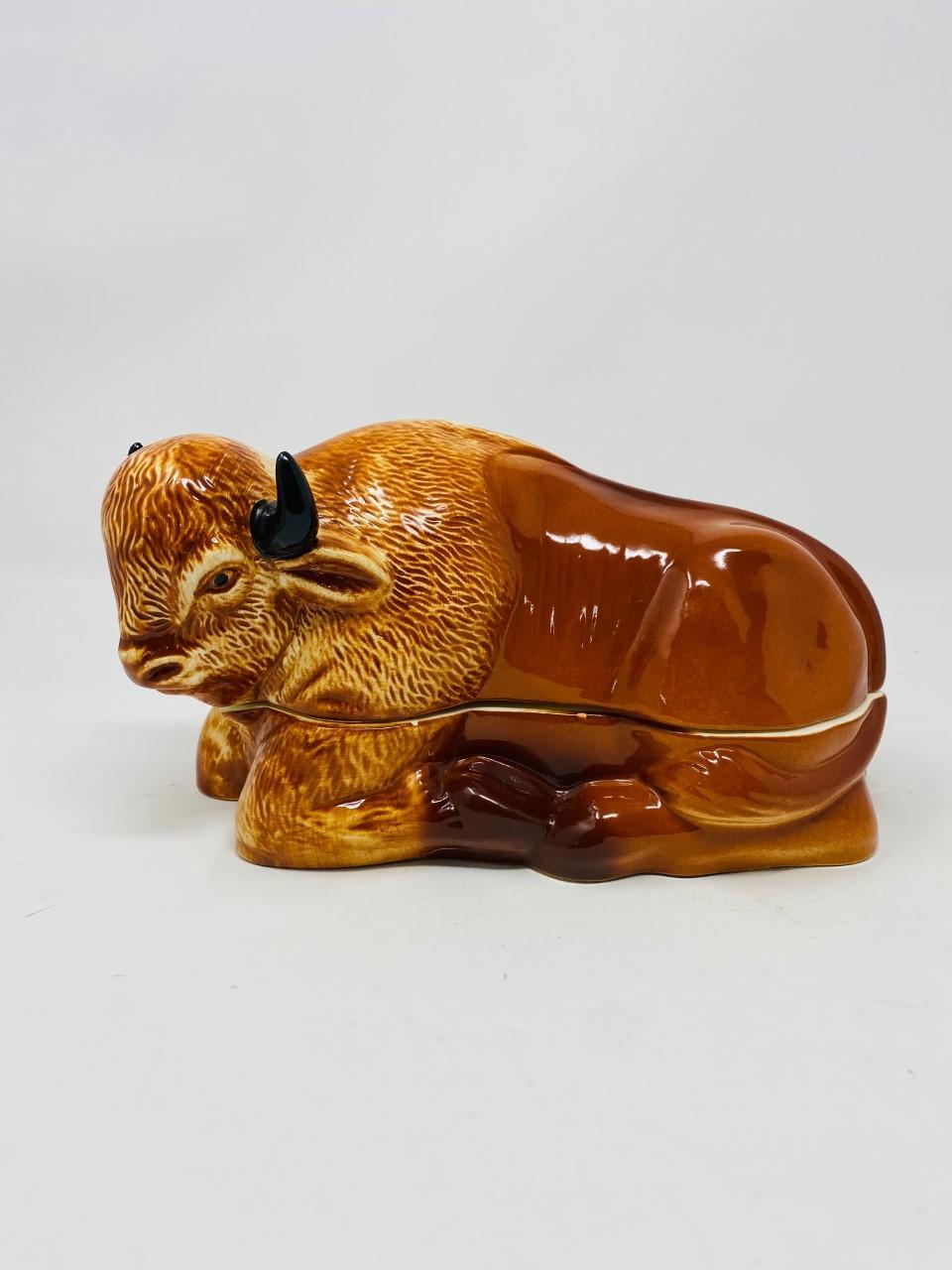 A large vintage figural recumbent Bison Pâté Terrine made for Laurent Caugant, a Bretagne pâté maker since 1927. His son Michel created these figural forms as containers for selling his fathers pâté in their luxury food shop. The two-piece terrine