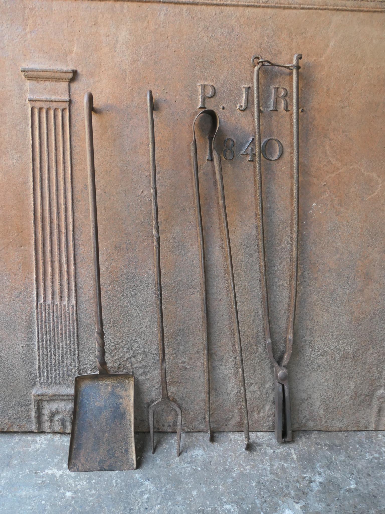Large 17th-18th century French fireplace tool set. The tool set consists of fireplace tongs, shovel, fire fork and log tongs. The tools are made of wrought iron. The set is in a good condition and fit for use in the fireplace.