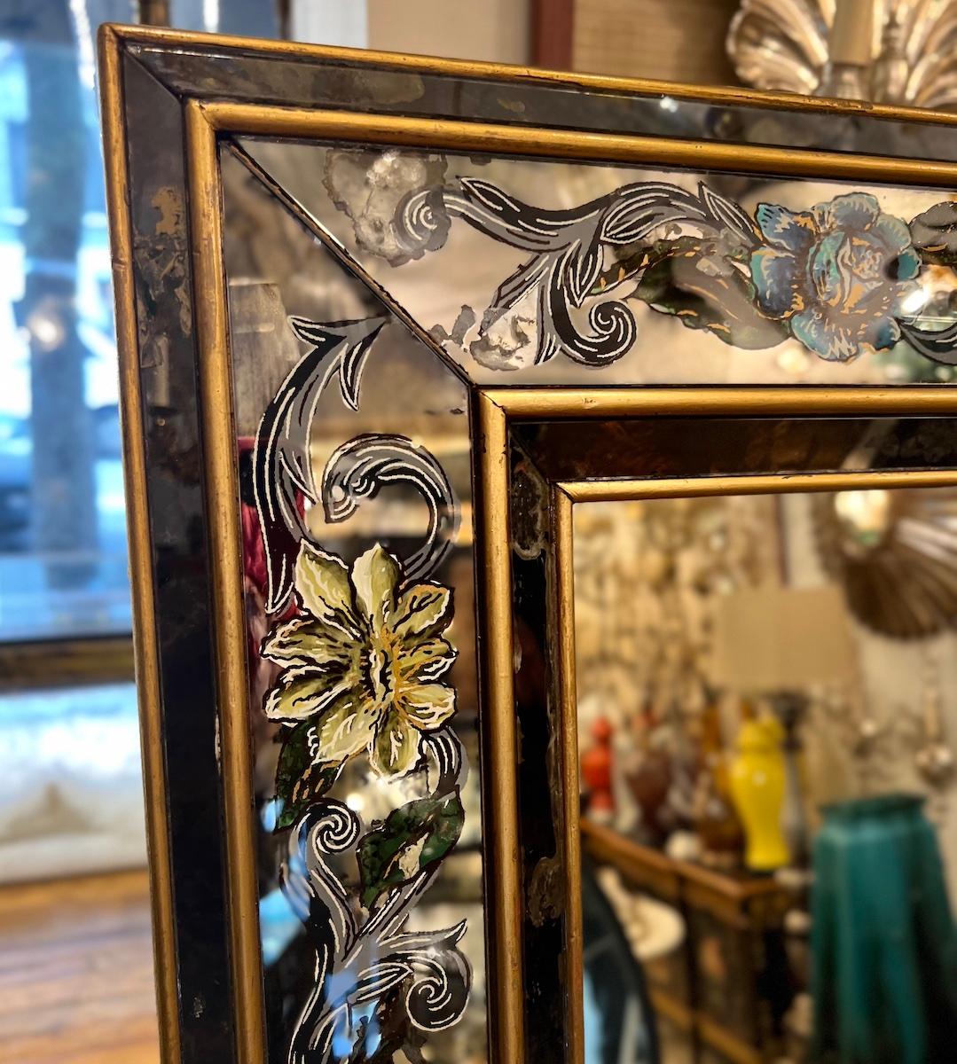 A circa 1950s French reverse-painted mirror with floral decoration.

Measurements:
Height: 56.75