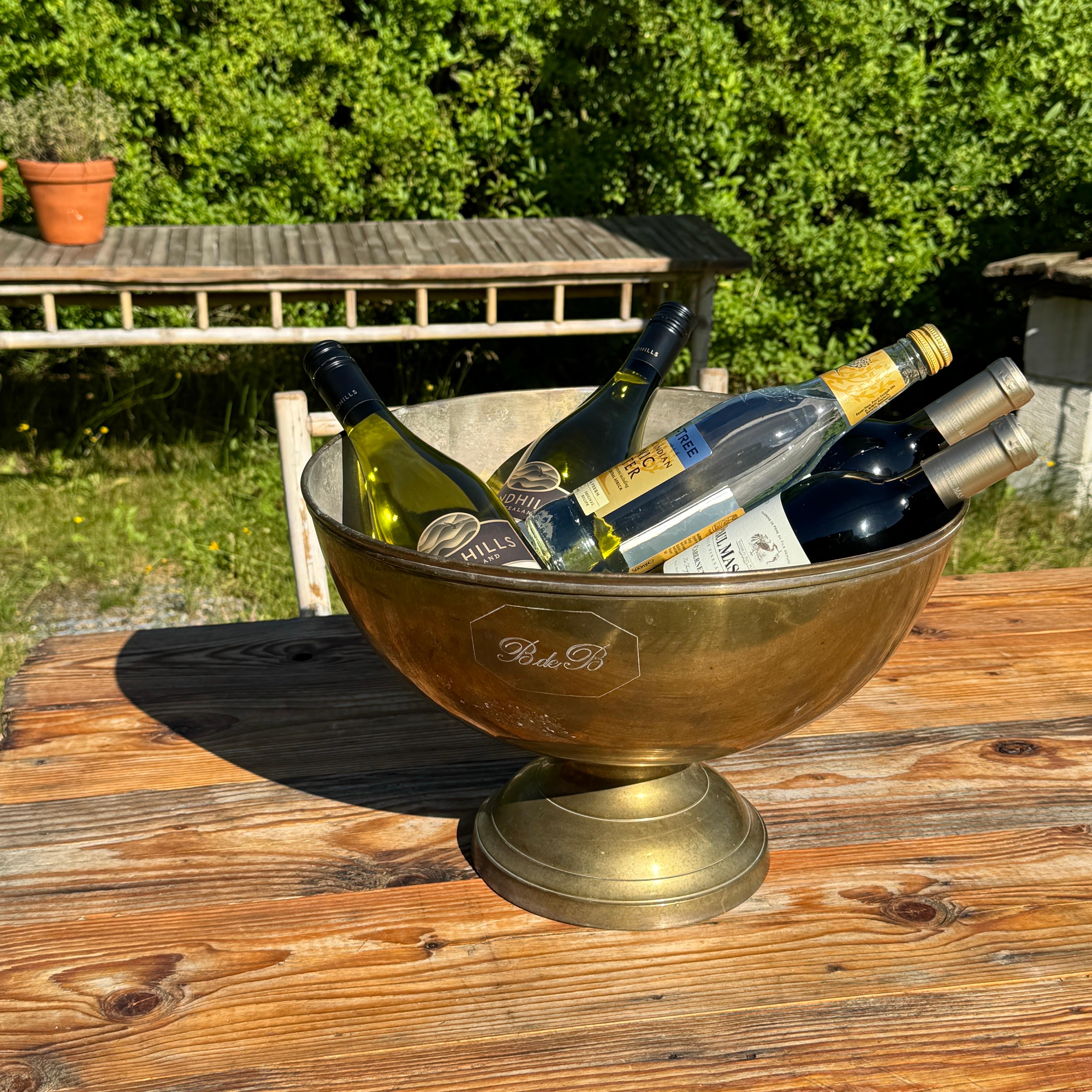 This vintage champagne bucket, from the 1960’s, has a brass finish and is quite heavy. There is a gold brand reading B de B on the side. As seen throughout Europe this hand-cast bucket will elevate any occasion. Featuring a brass finish, the texture