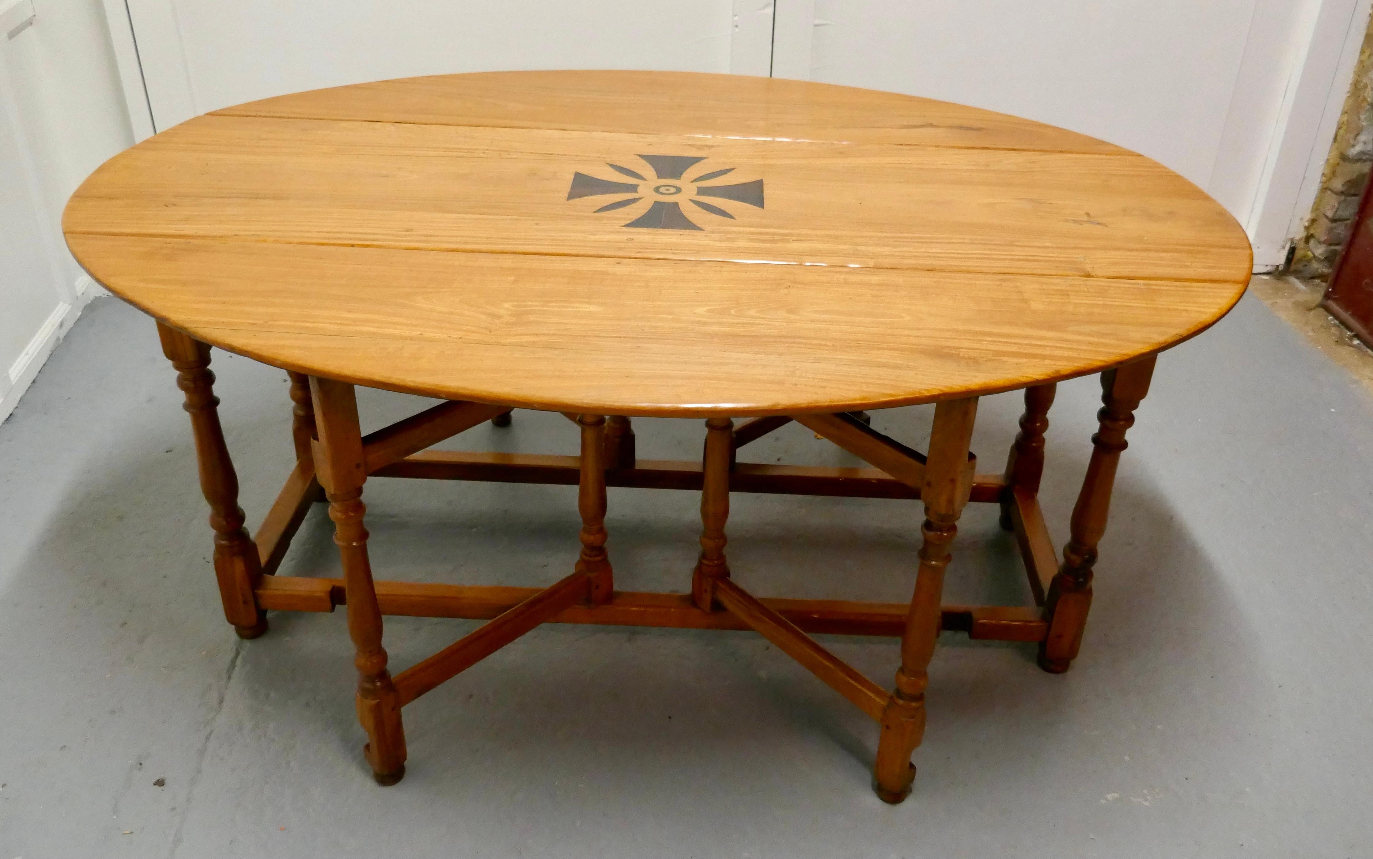 Large French Gate Leg Dining Table  

This is a large table with double gate leg at each side to support the long deep leaves, it has attractive turned legs and cross members
The table has a small piece of wood let in on the top, this has probably