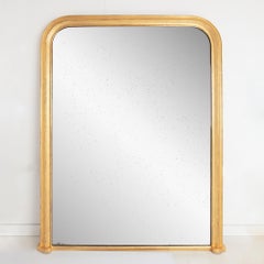 Grand miroir surmonté d'un manteau doré français, vers 1840