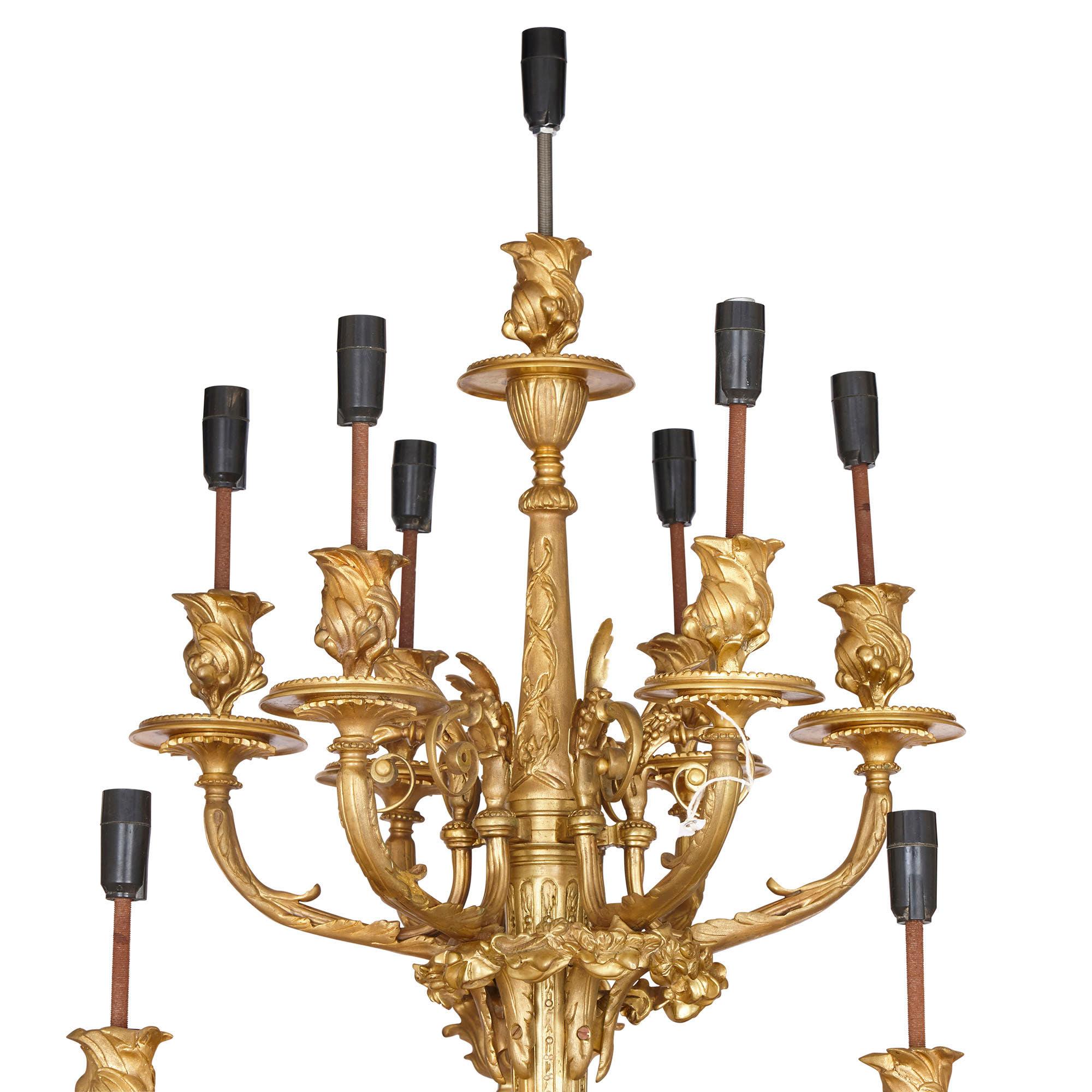 Large French gilt bronze wall sconces
French, 20th century
Measures: Height 165cm, width 83cm, depth 63cm

Each twelve-branch sconce in this pair, both crafted from gilt bronze in the Louis XV style, is unusually large. Each sconce features