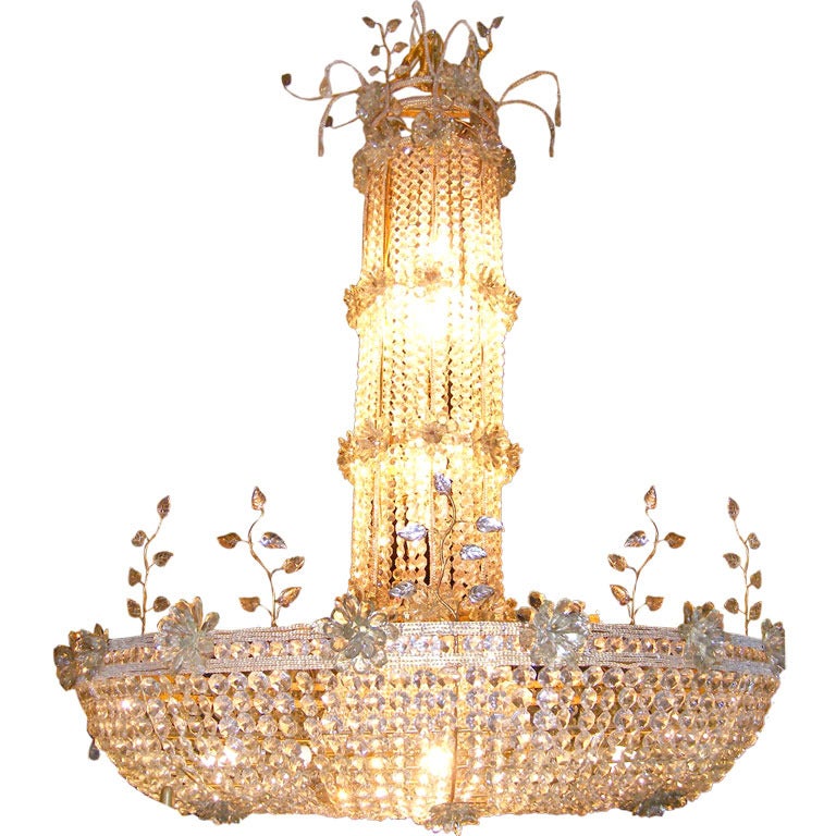 A very large French Bagues style gilt metal and crystal chandelier with interior lights. The gilt metal body has beaded crystal drops and the interior lights are covered by woven crystals from the top.

Measurements
Height 76?
Diameter 50?.
