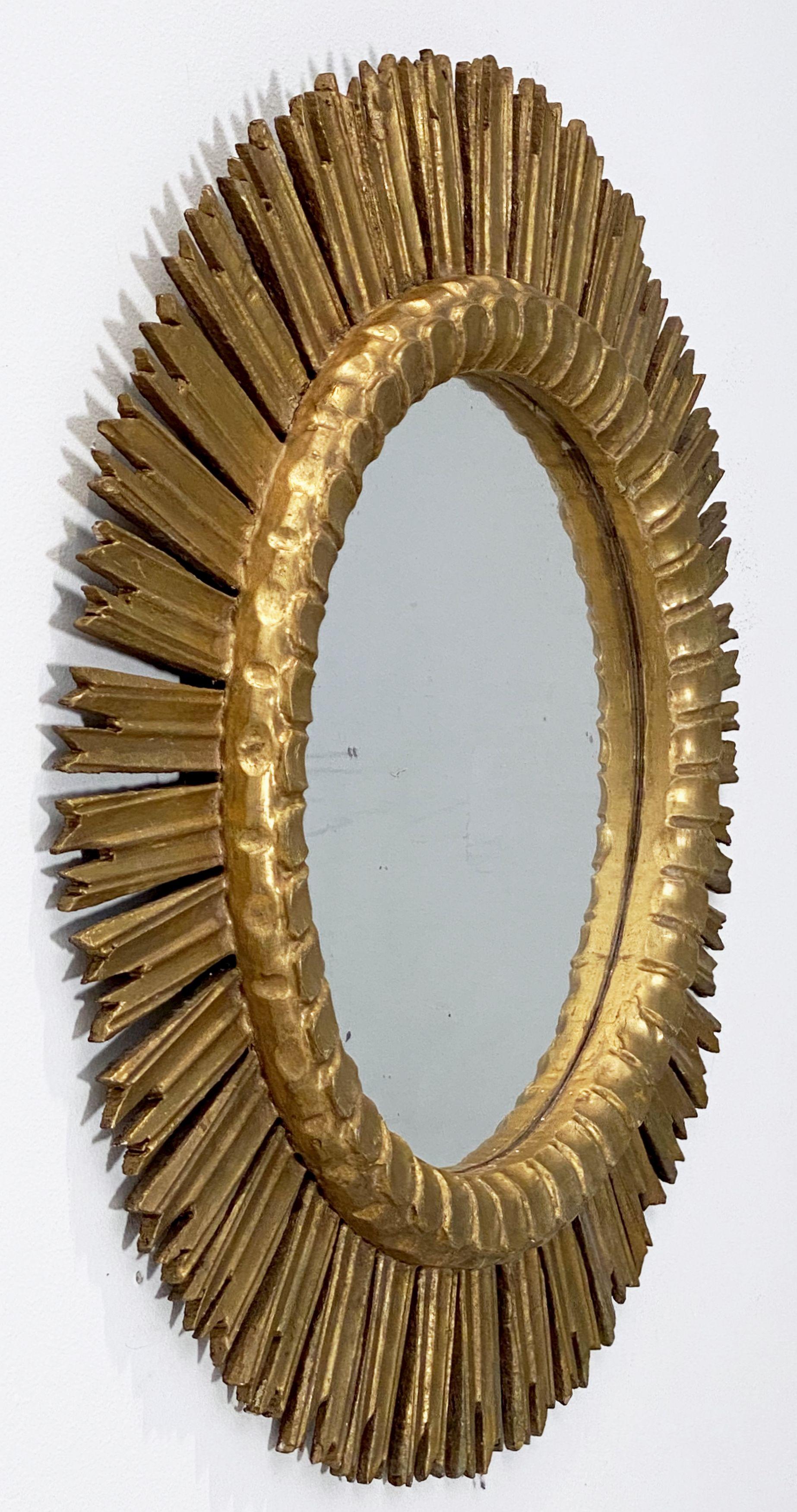 A lovely large French gilt sunburst (or starburst) mirror with round mirrored glass center in a moulded frame.

Diameter of 25 1/2 inches