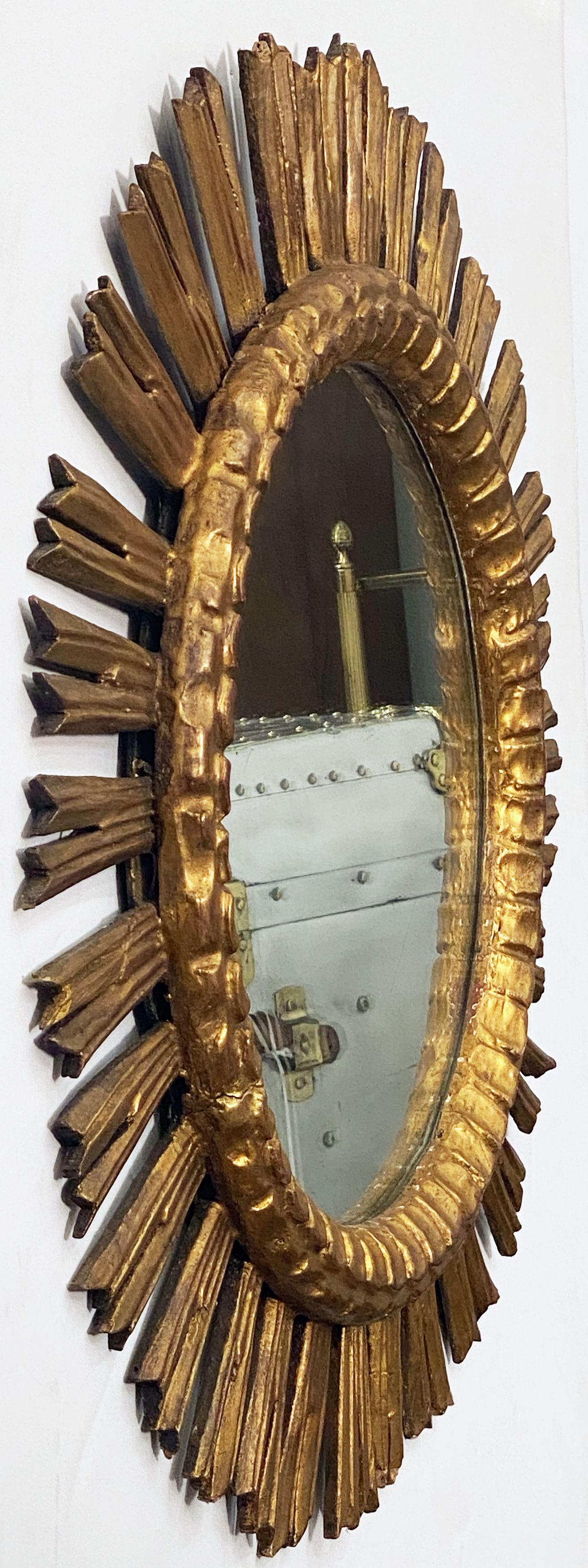 A lovely large French gilt sunburst (or starburst) mirror with round mirrored glass center in a moulded frame.

Diameter of 25 inches.