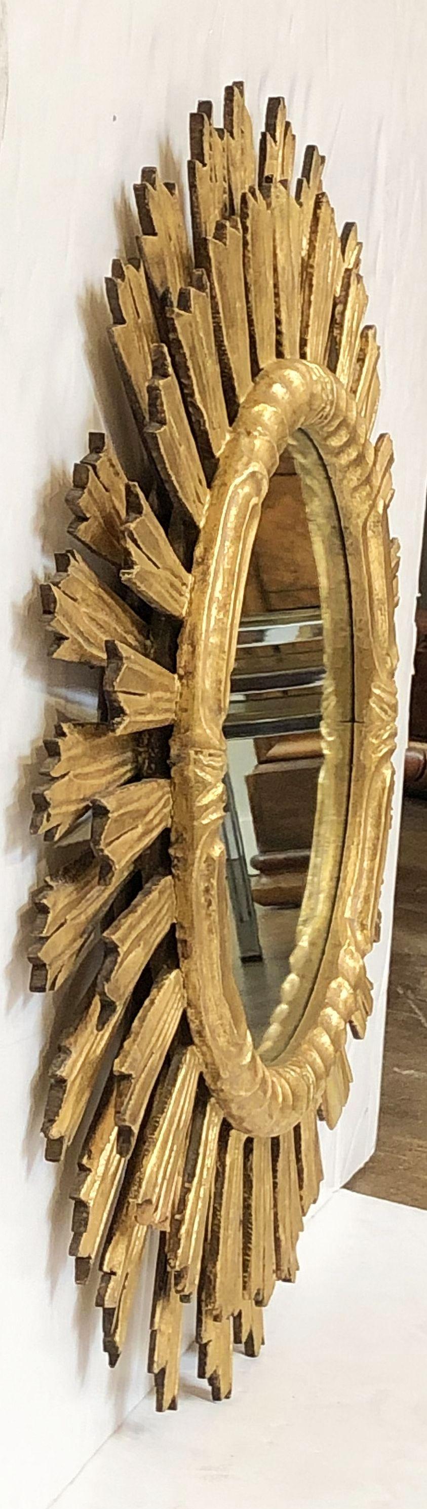 A lovely large French gilt sunburst (or starburst) mirror, 29 inches diameter with round mirrored glass center in a moulded frame.
