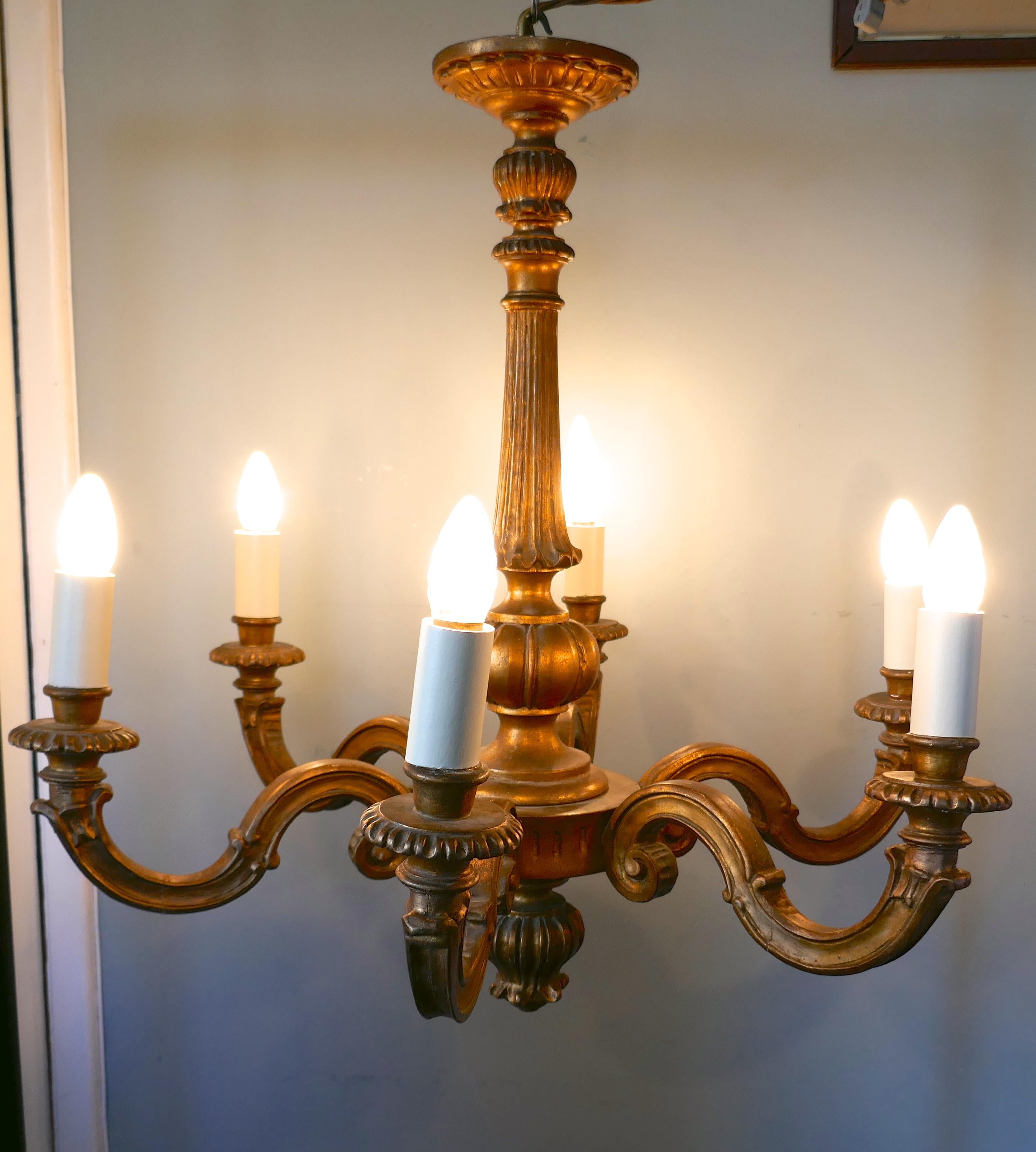 A large French giltwood 6-branch Rococo chandelier 

This is an superb large decorative chandelier, it is has a superb aged darkened finish 
The chandelier has 6 branches, and is carved and decorated in the Rocco fashion 
The wiring seems to be