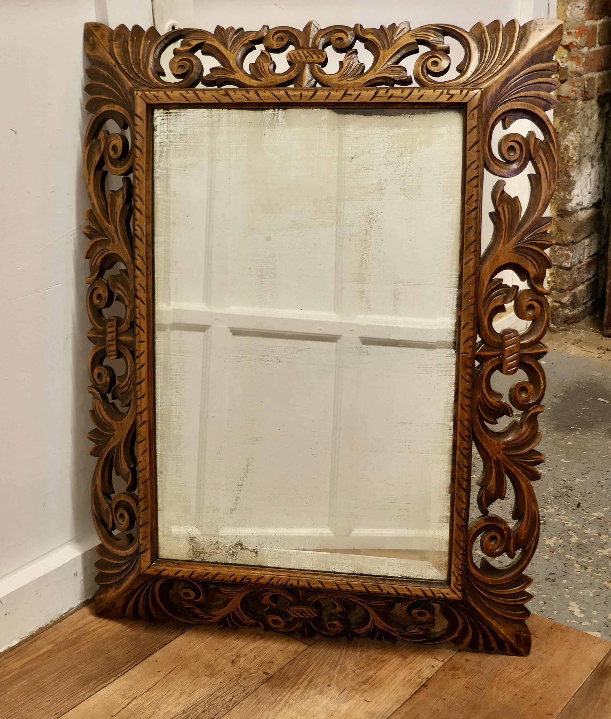 Large French Gothic Carved Oak Mirror

The 6” wide Oak Mirror Frame has pierced carving with acanthus leaves all the way around.
 The frame has a good polished patina and it retains the old bevelled looking glass, this has areas of foxing keeping