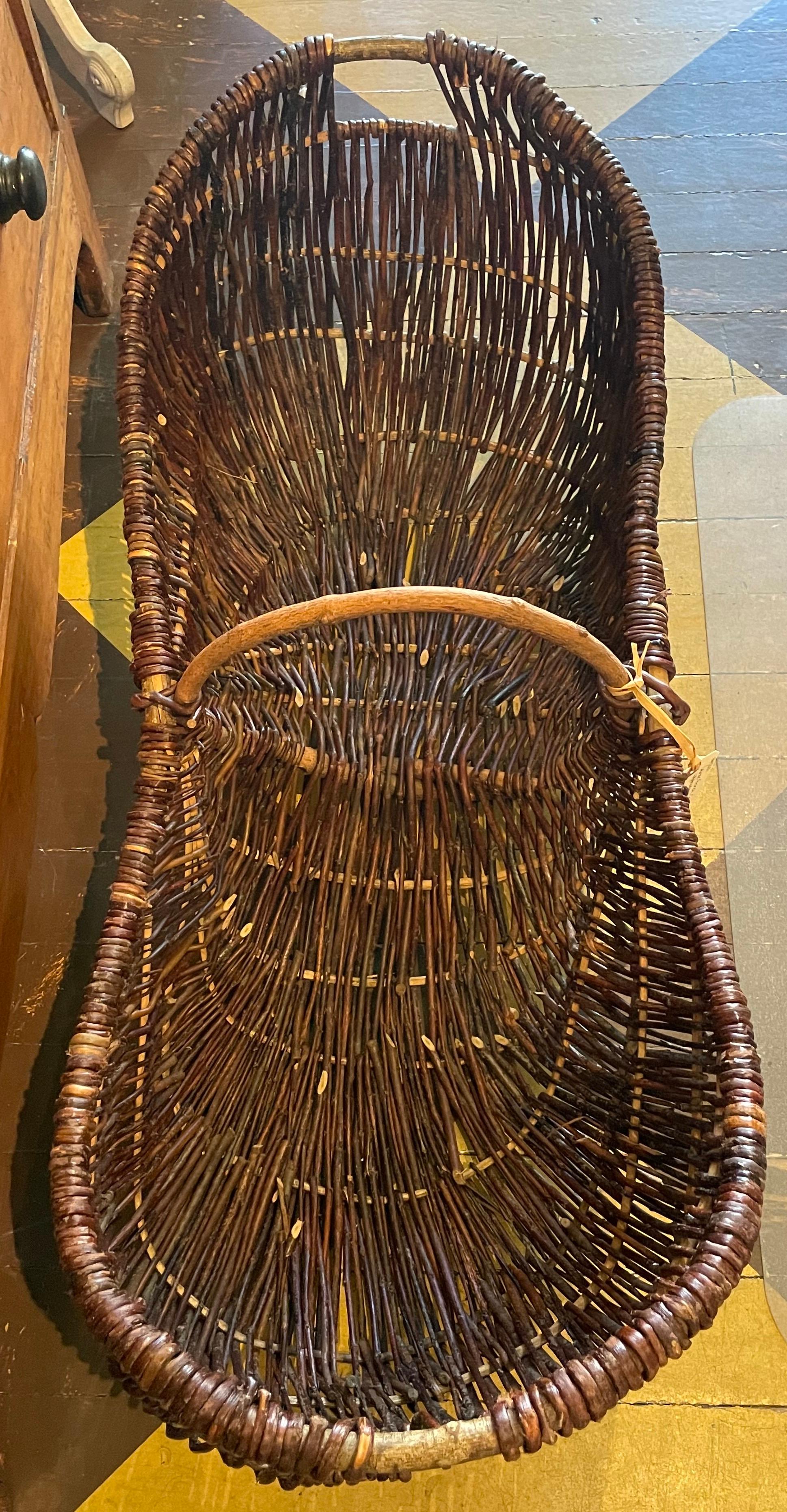 Lovely large grape harvesting/gathering basket from the Burgundy region of France. Handwoven with wicker over wooden frame, with central arched carrying handle.