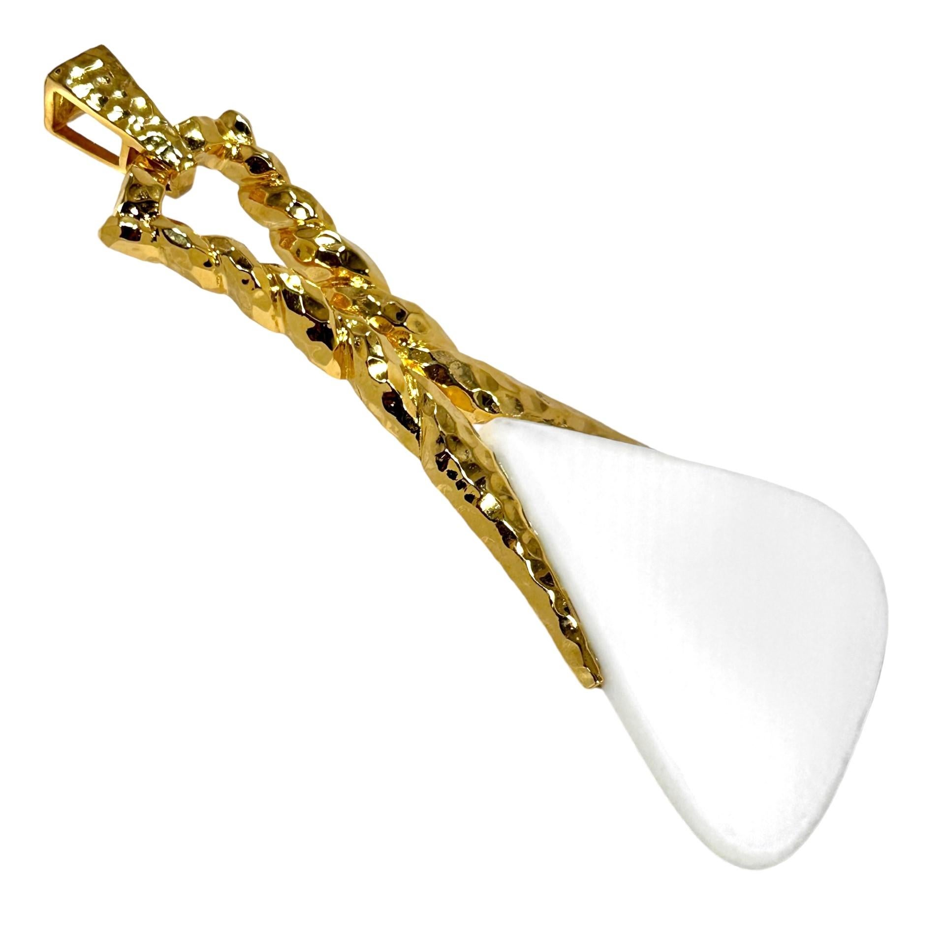 This magnificent 14k yellow gold and white onyx pendant by Wander is a very well crafted example of the hammered finishes of the 1960's and 1970's. It is big, bold and brash, measuring a full 4 3/8 inches in length by 2 1/8 inches in width. The very