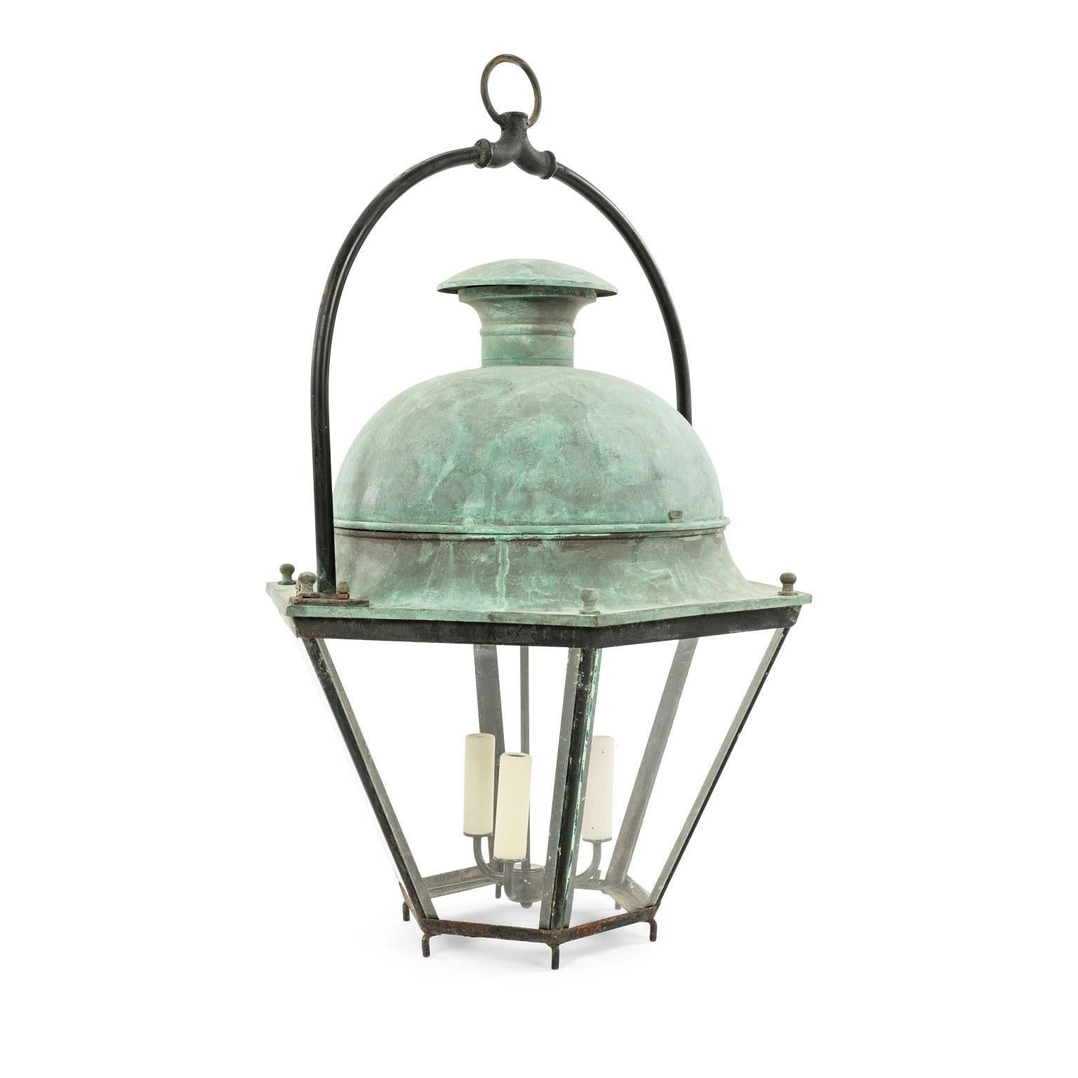 Large French hexagonal green-verdigris copper lantern with domed top and enclosed by glass paneled sides. This vintage lantern originally served as a street light in the South of France. Now features three new candelabra-size lights. Newly wired for
