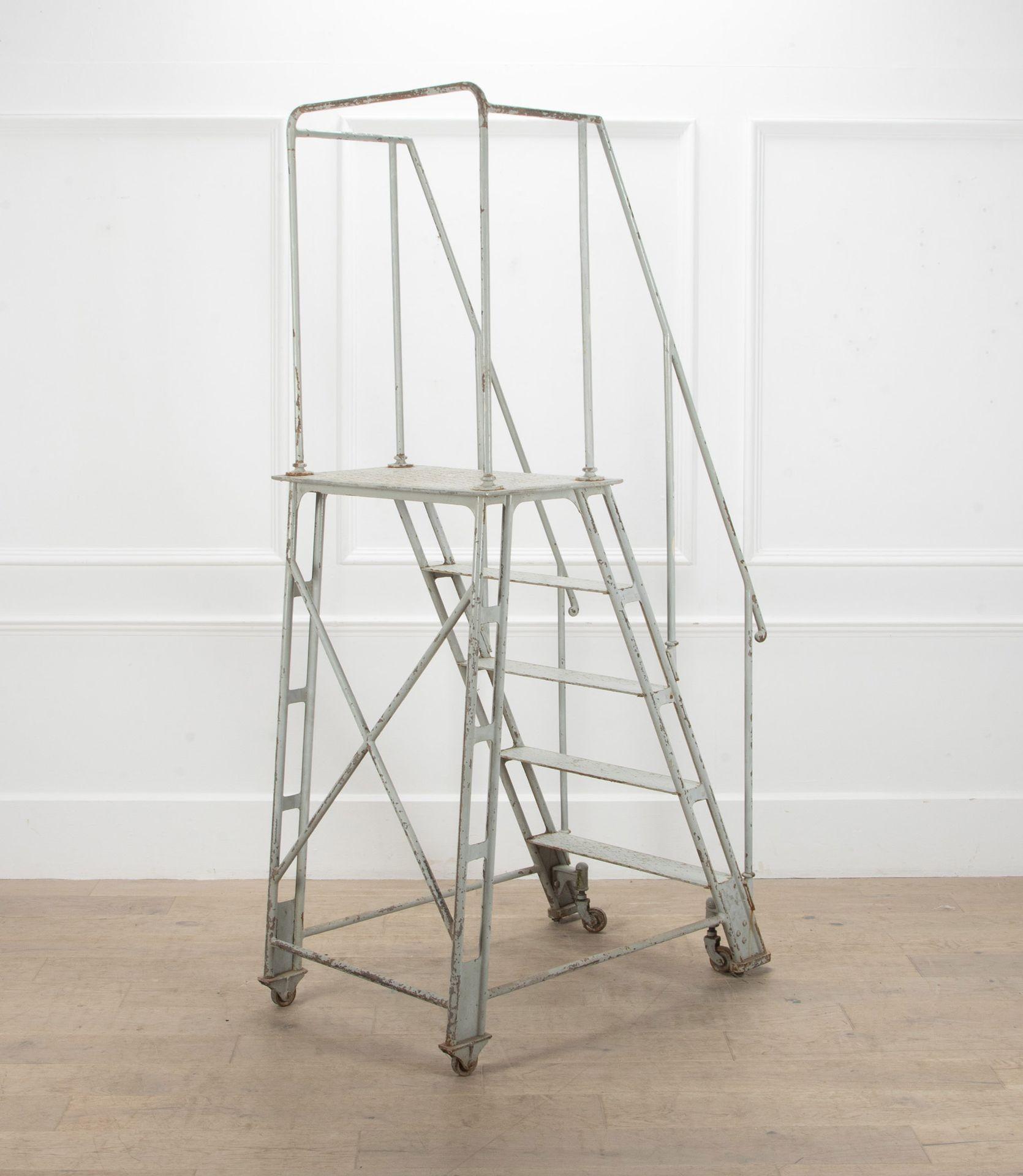 French industrial iron library ladder, originally used in a bank. Circa 1900.

This ladder has a practical design, with wheels for ease of movement, a hand rail and five steps. 

The ladder would have been used previously to reach documents and
