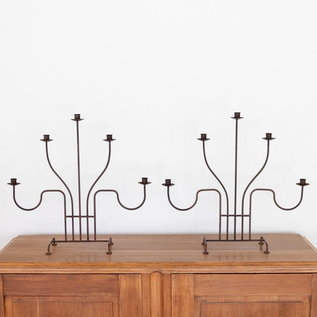 Impressive large vintage iron five arm candelabra from France. Thin curved arms and four leg iron base. Great age and patina to finish. One available. 