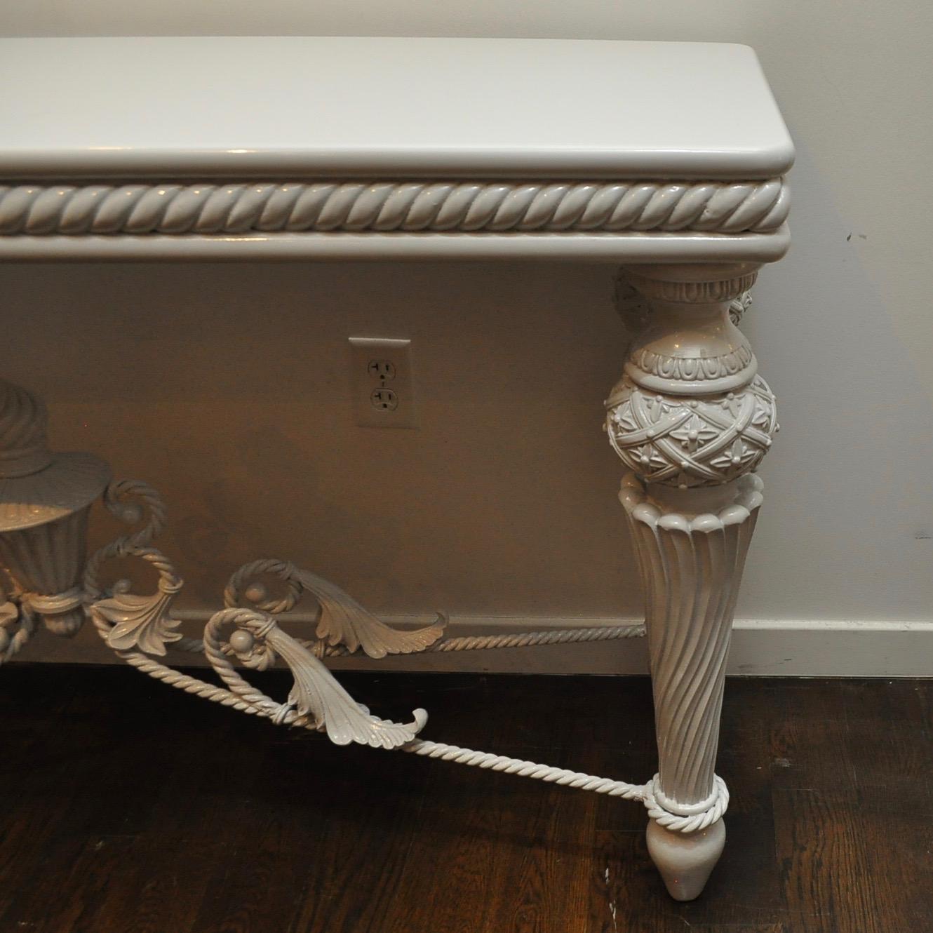 Dramatic french influence wrought iron and wood console table refreshed with a light grey high-gloss lacquer.