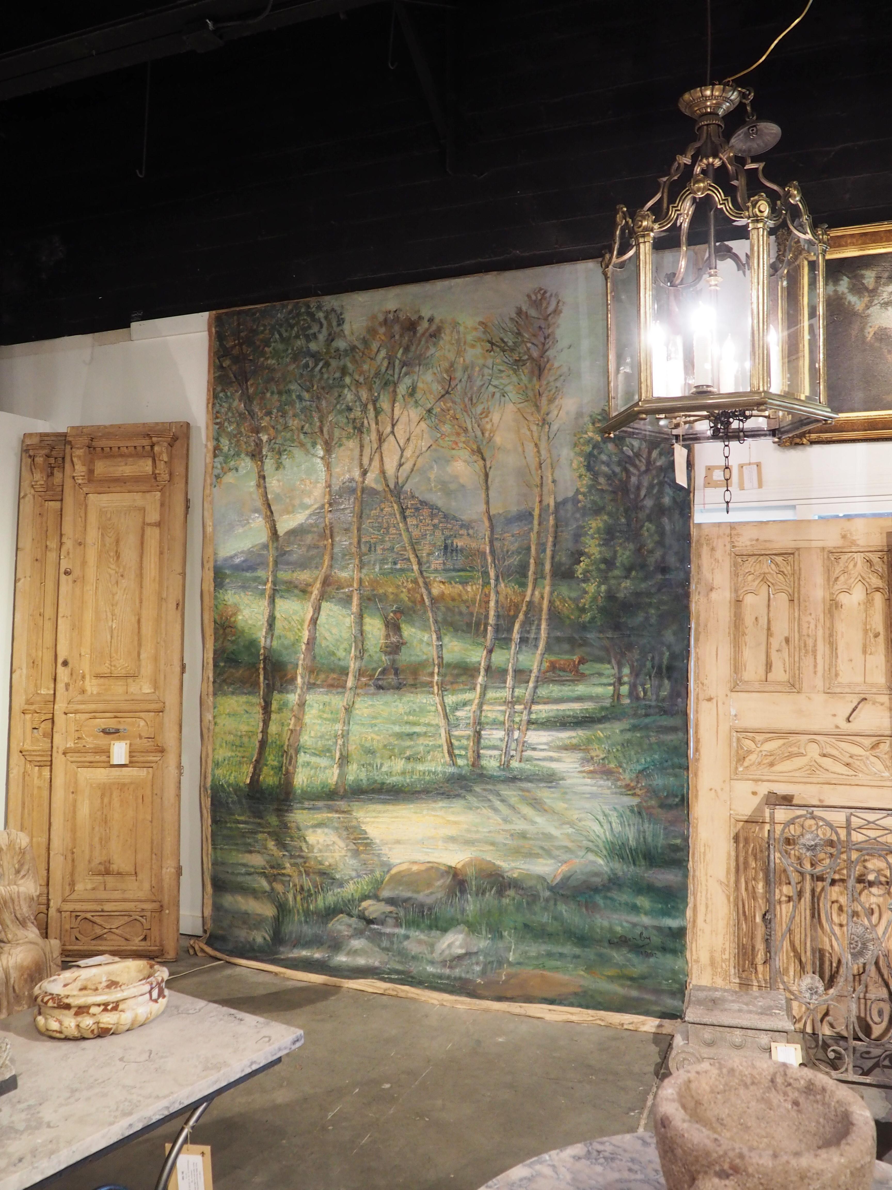 Hand-Painted Large French Landscape Painting of a Hunter and Hillside Village, Dated 1962 For Sale