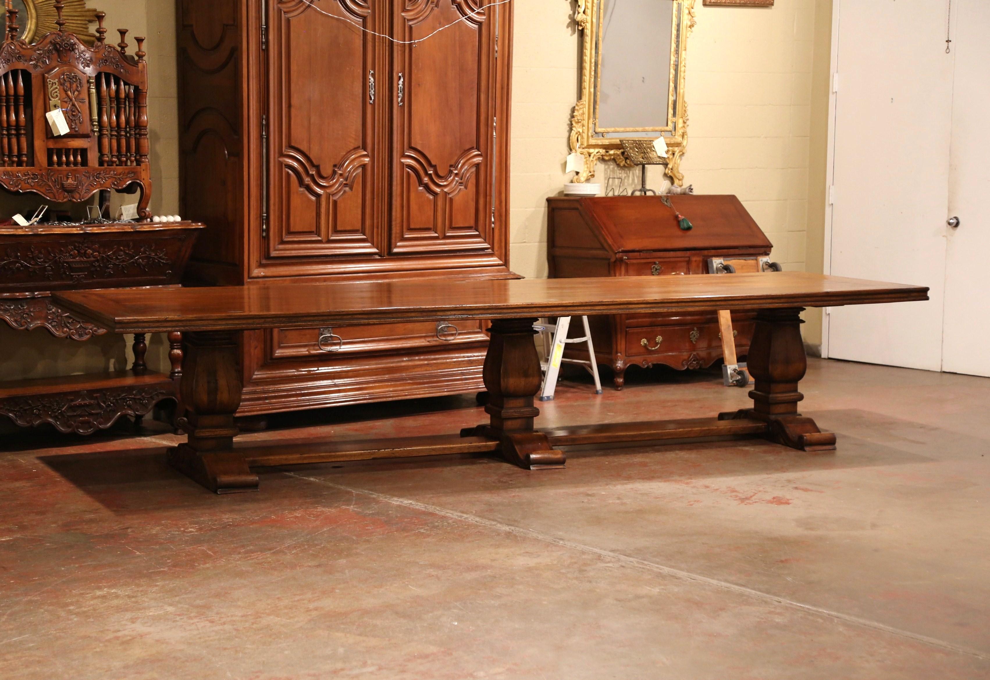 Patinated Large French Louis XIII Style Walnut Trestle Farm Table with Three Carved Legs