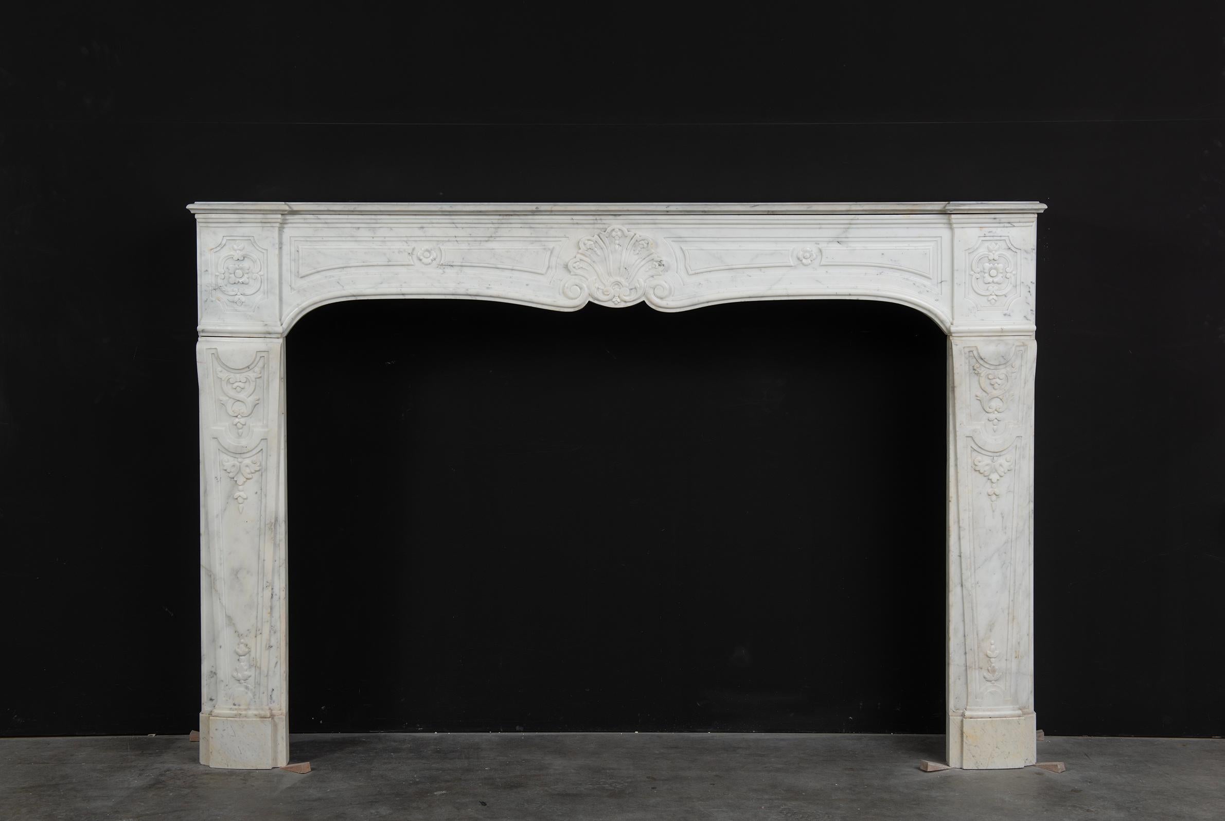 A nice tall and Large French Louis XV Fireplace Mantel.

The shaped topshelf has a lovely elegant designed profiled edge the frieze it rests on has lovely simplified floral decoration, one on both endblocks and a large foliage in the middel.
The