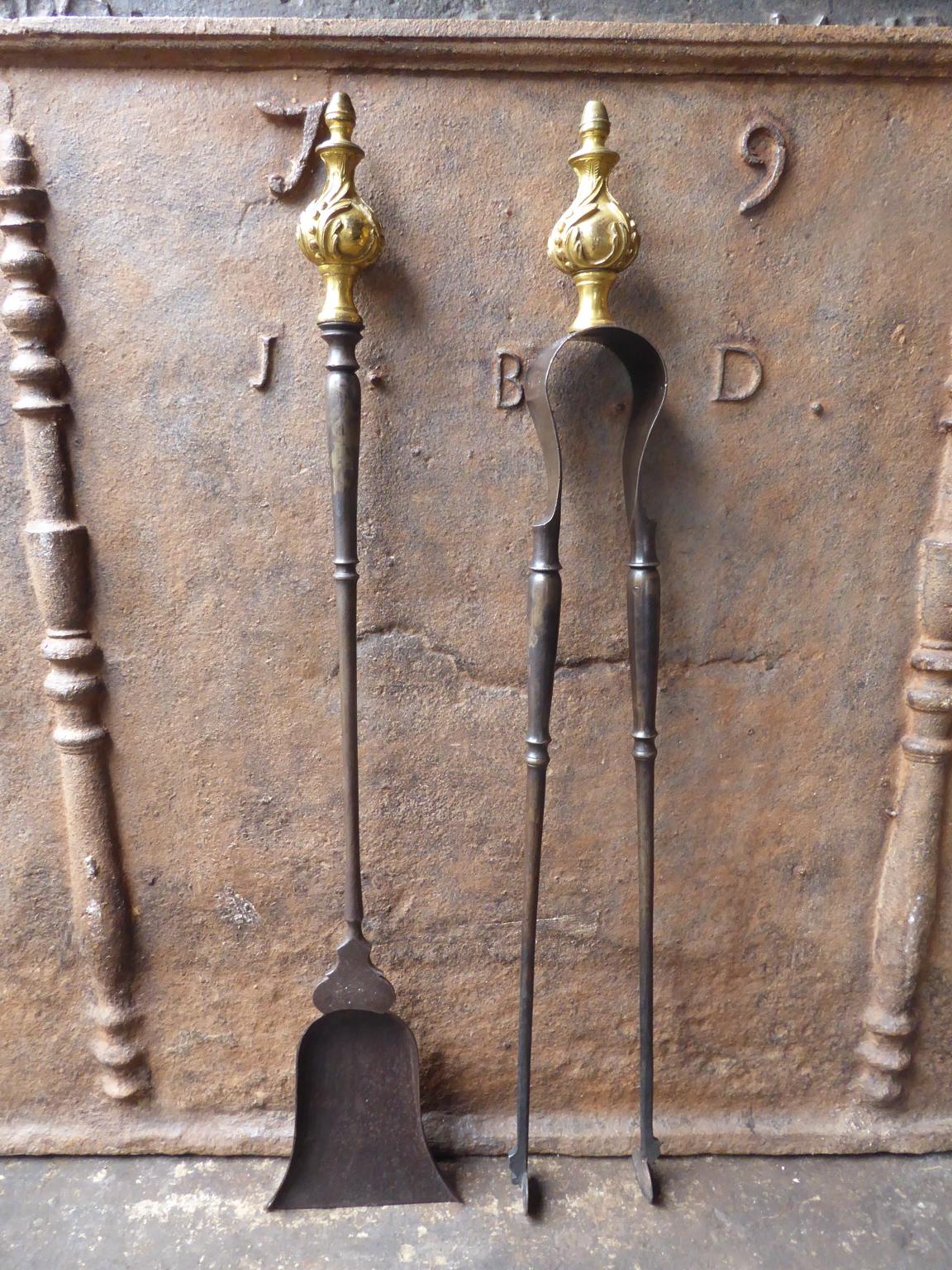 Large 18th century French Louis XV fireplace tool set consisting of fireplace tongs and a shovel. The fire irons are made of wrought iron with a bronze handle. They are in a good condition and are fully functional.